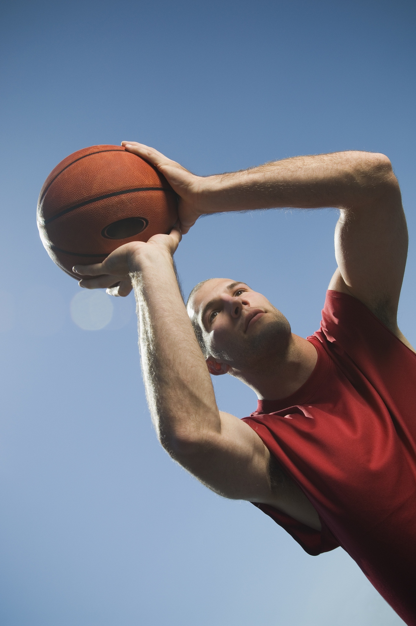 man shooting basketball