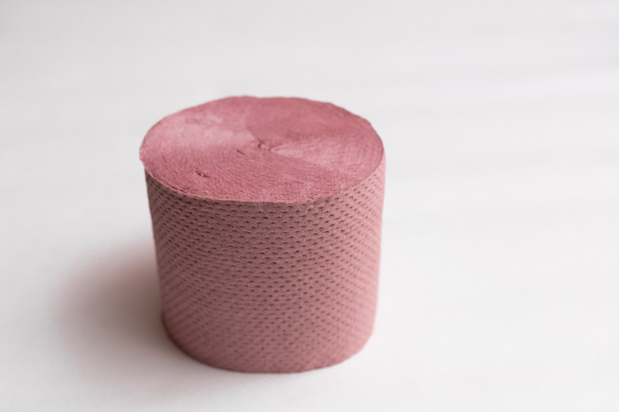 roll of pink toilet paper on a white background.deficient produc