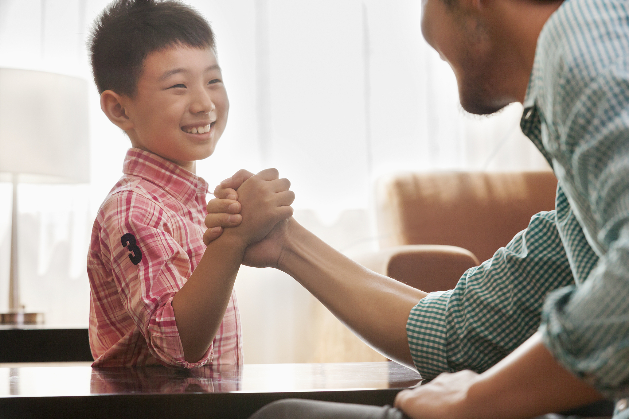 father and son arm wrestling