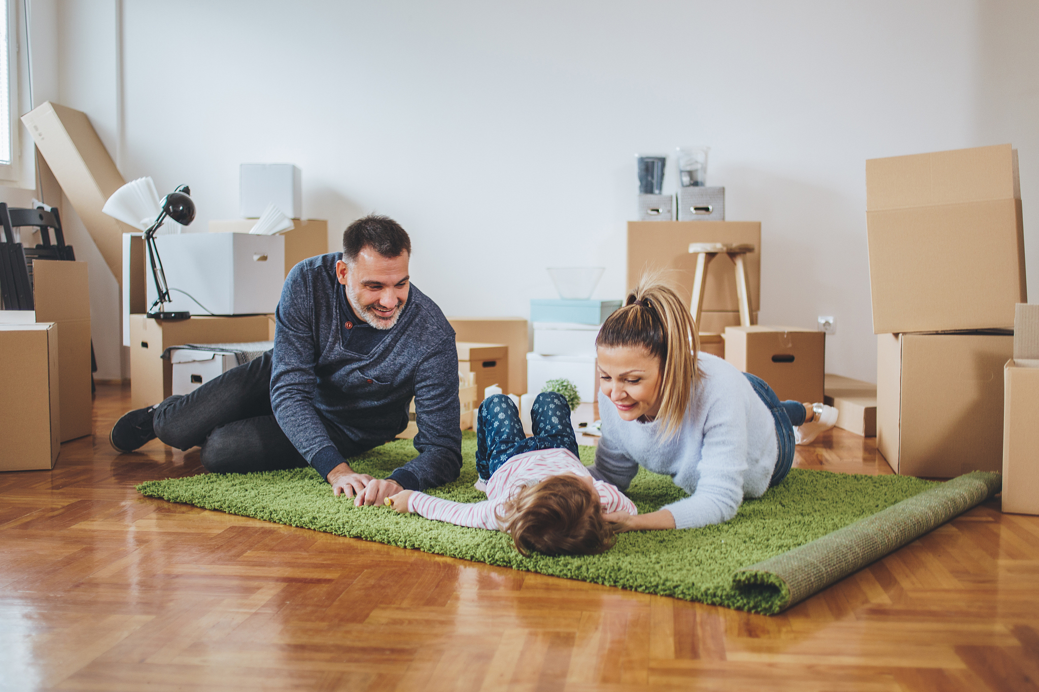 family unpacking in a new apartment and having fun