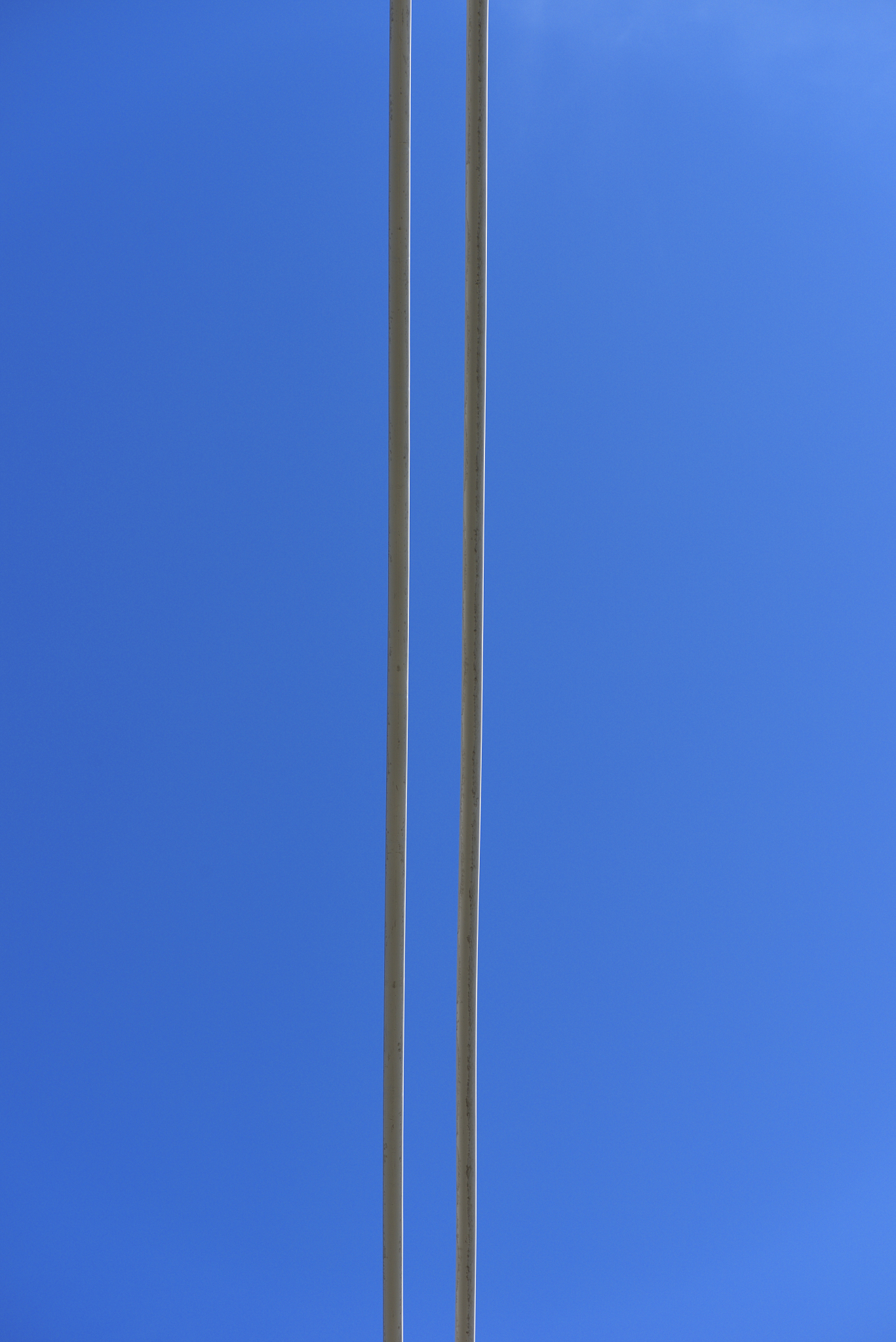 metal cables of a huge suspension bridge against clear sky