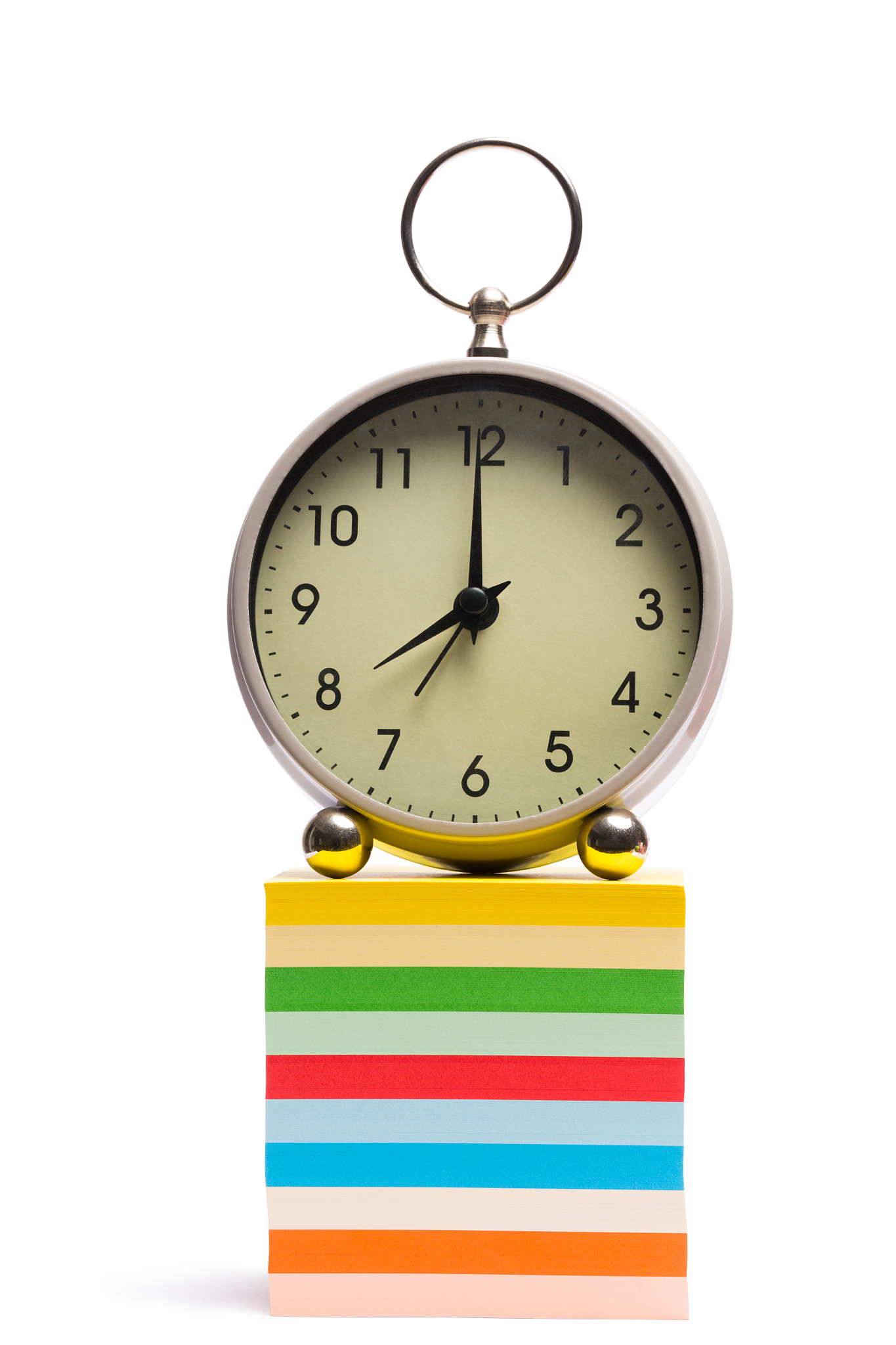 alarm clock on pile of sticky notes