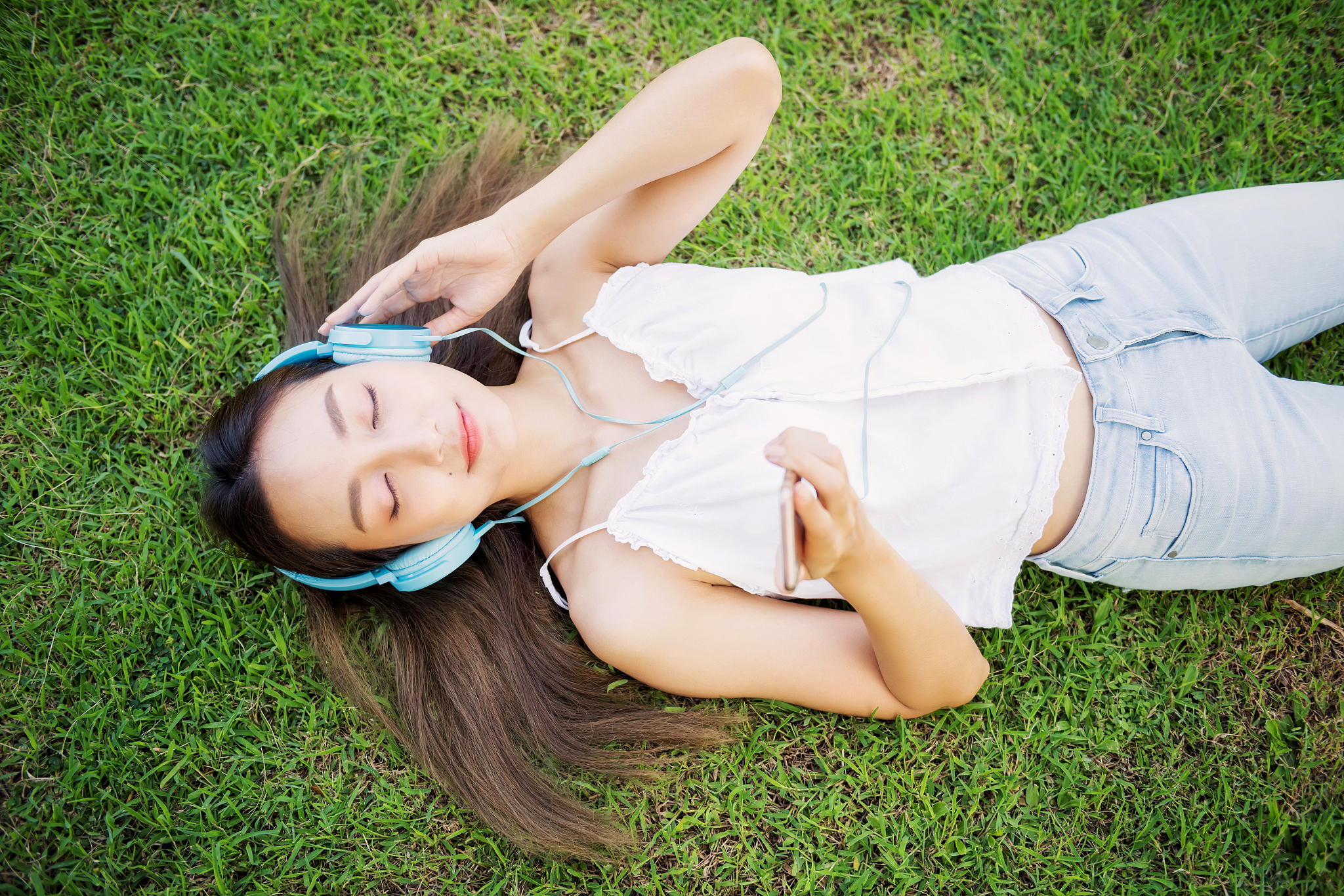 beautiful girl relax with smartphone in park
