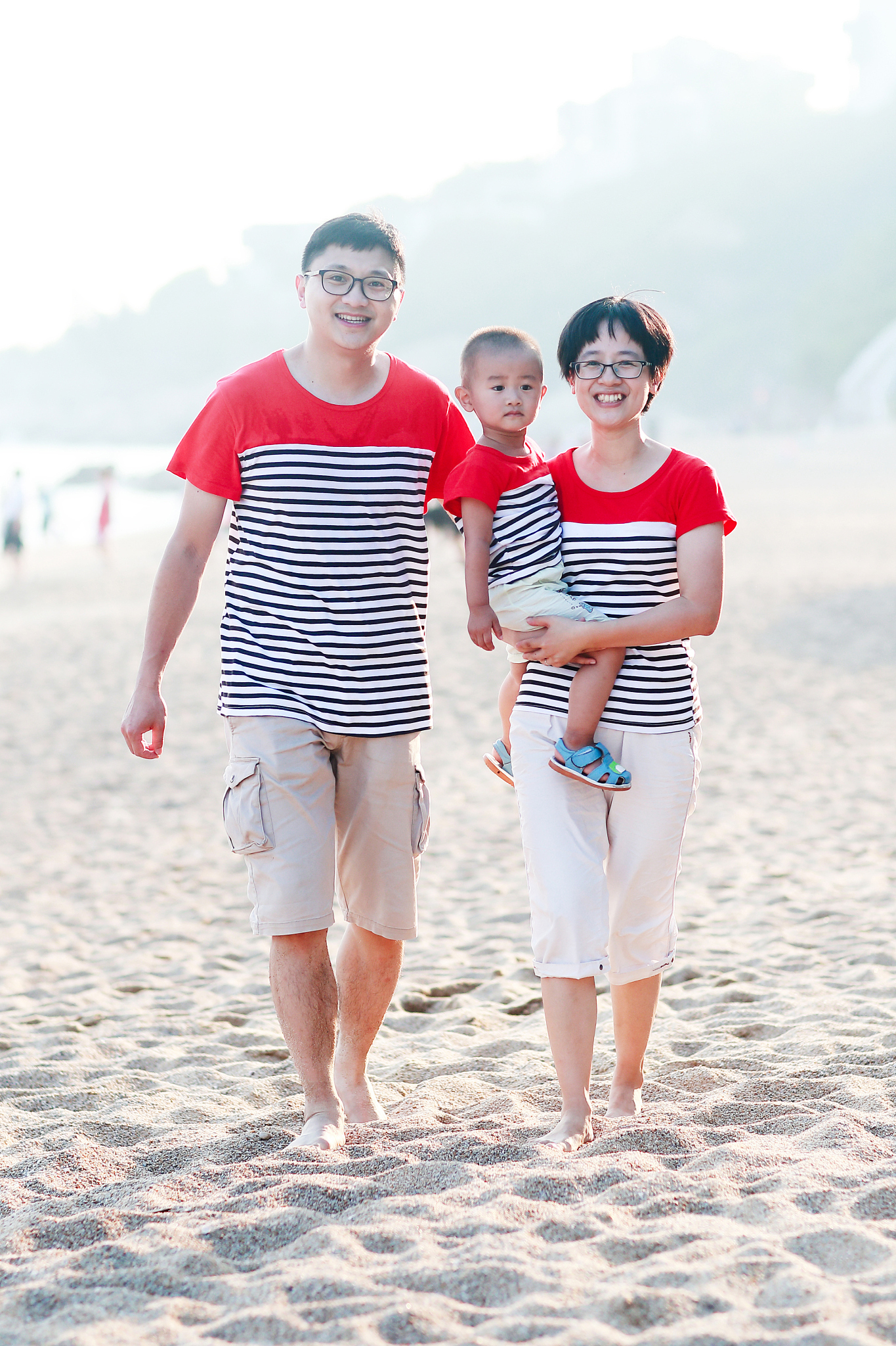 happy asian families play on the beach