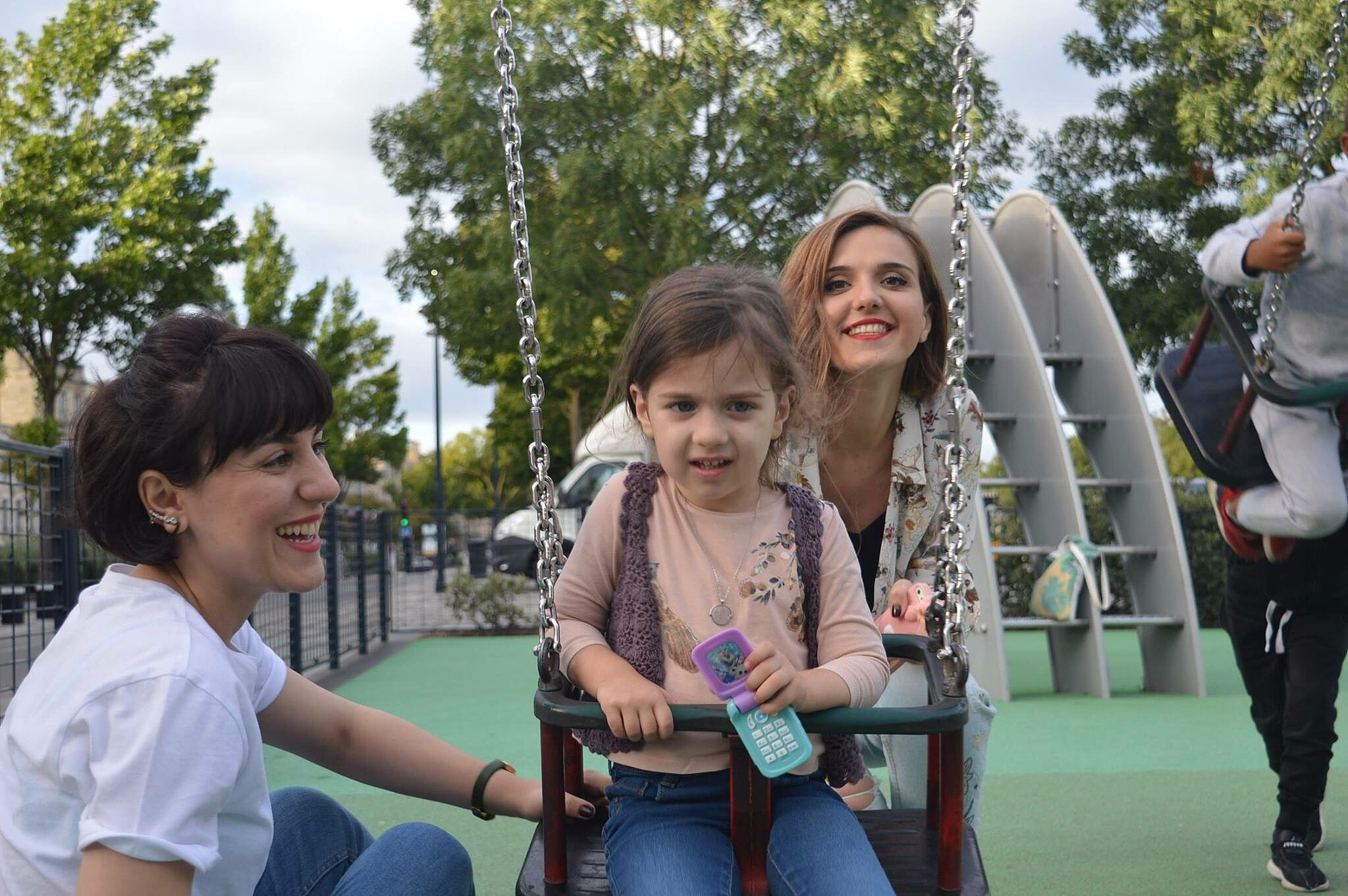 young women with girl at park