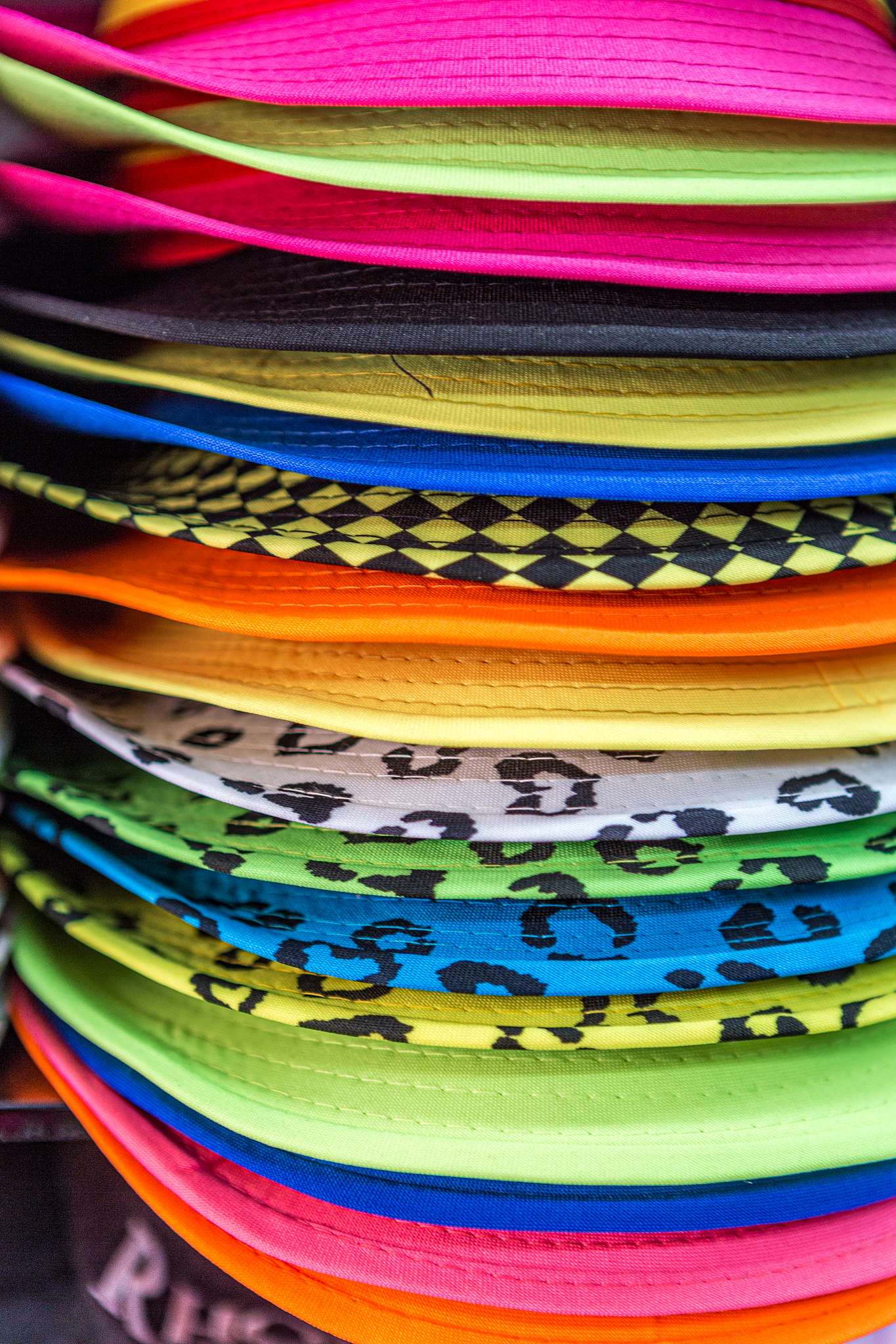 a stack of summer colorful sun hats