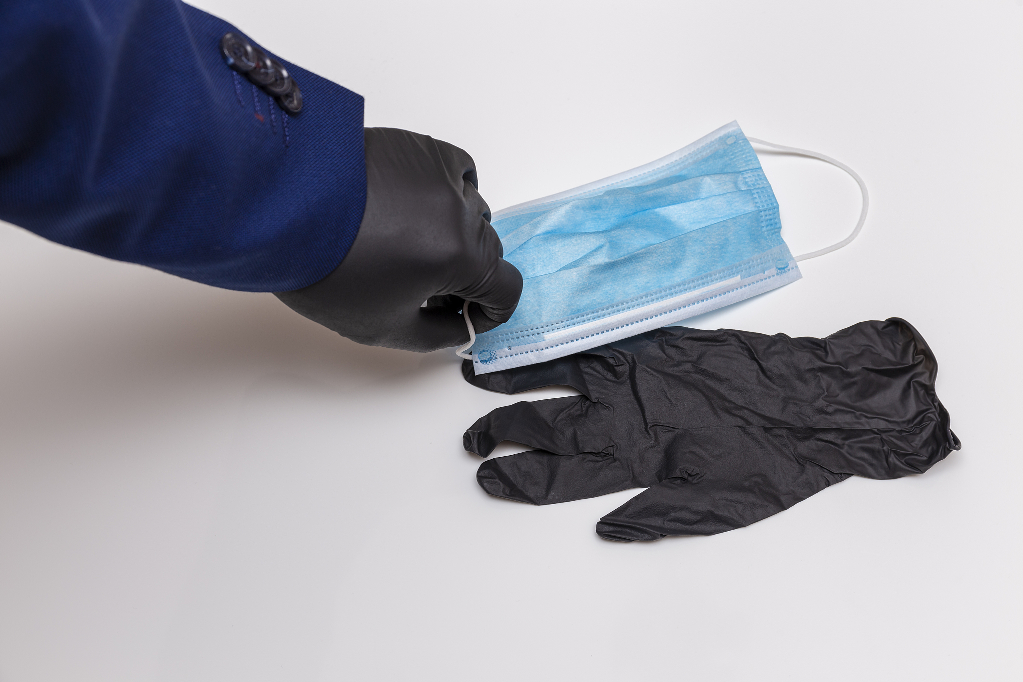for protection in the office hand wearing black gloves and surgi
