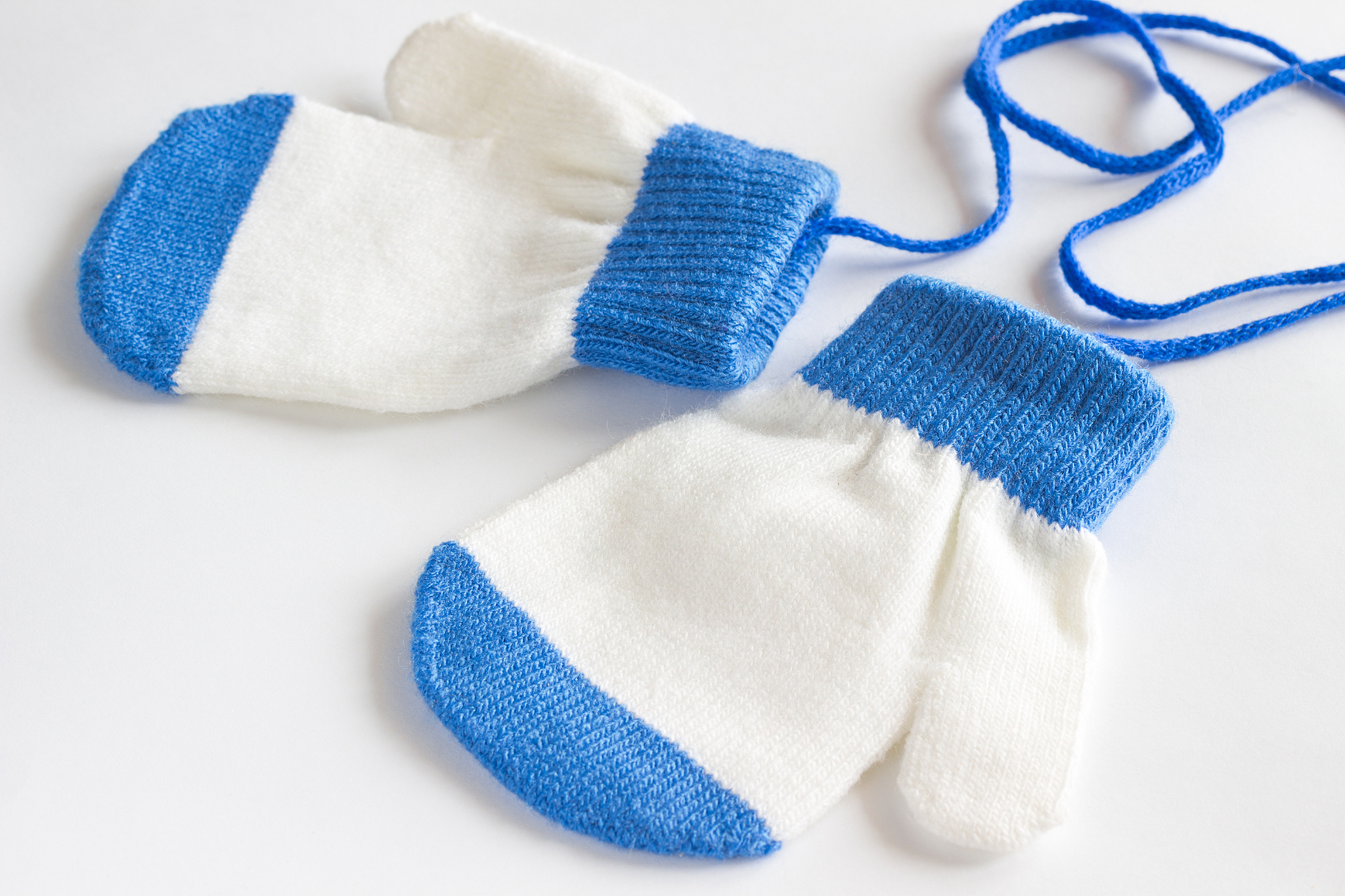 baby mittens on a white background