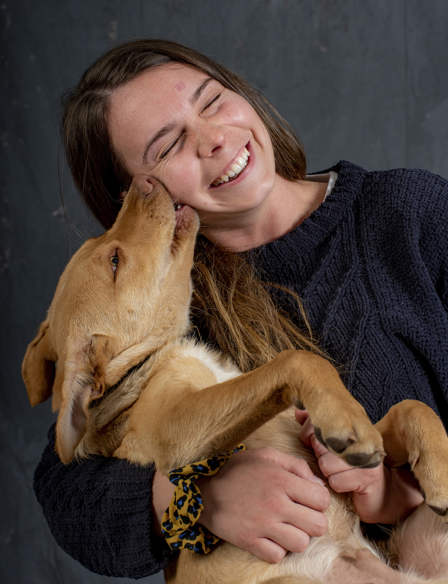 young woman with her three months old australian kelpie.