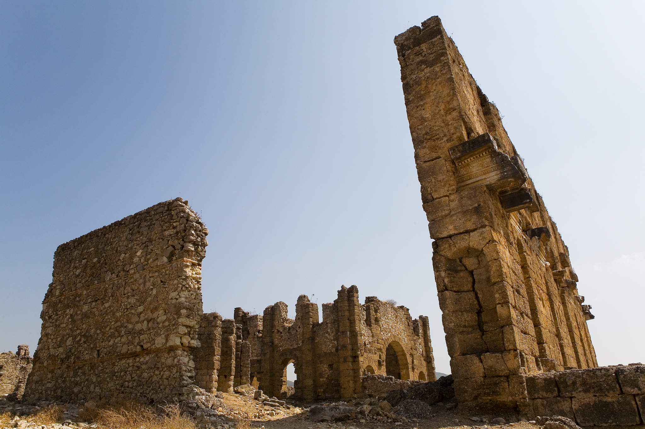 the ruins of the stone buildings of the ancient city of aspendos