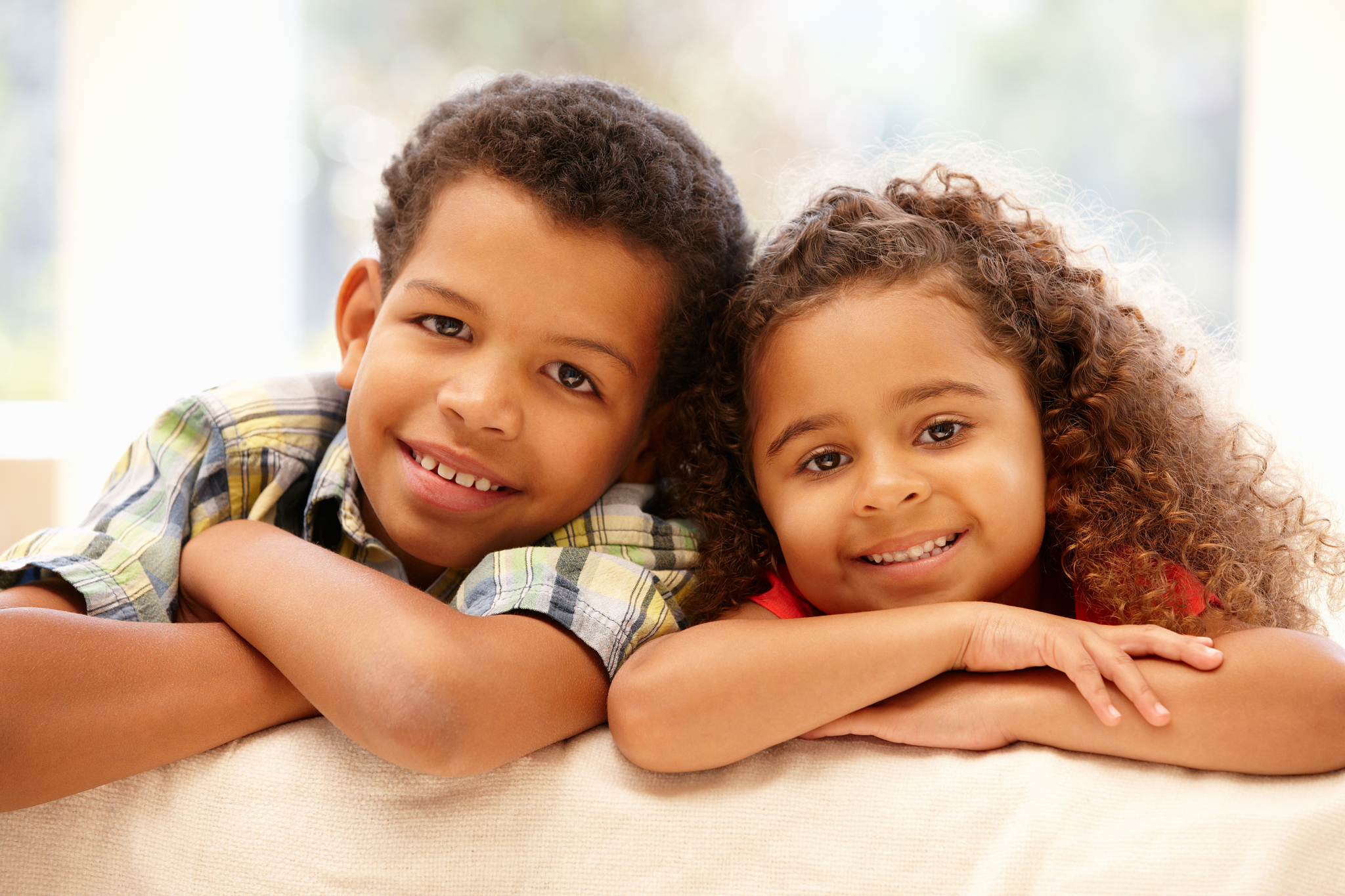 mixed race girl and boy at home