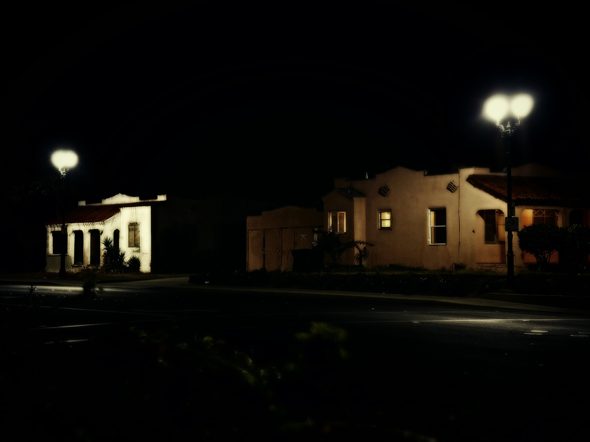 illuminated street lights and houses at night