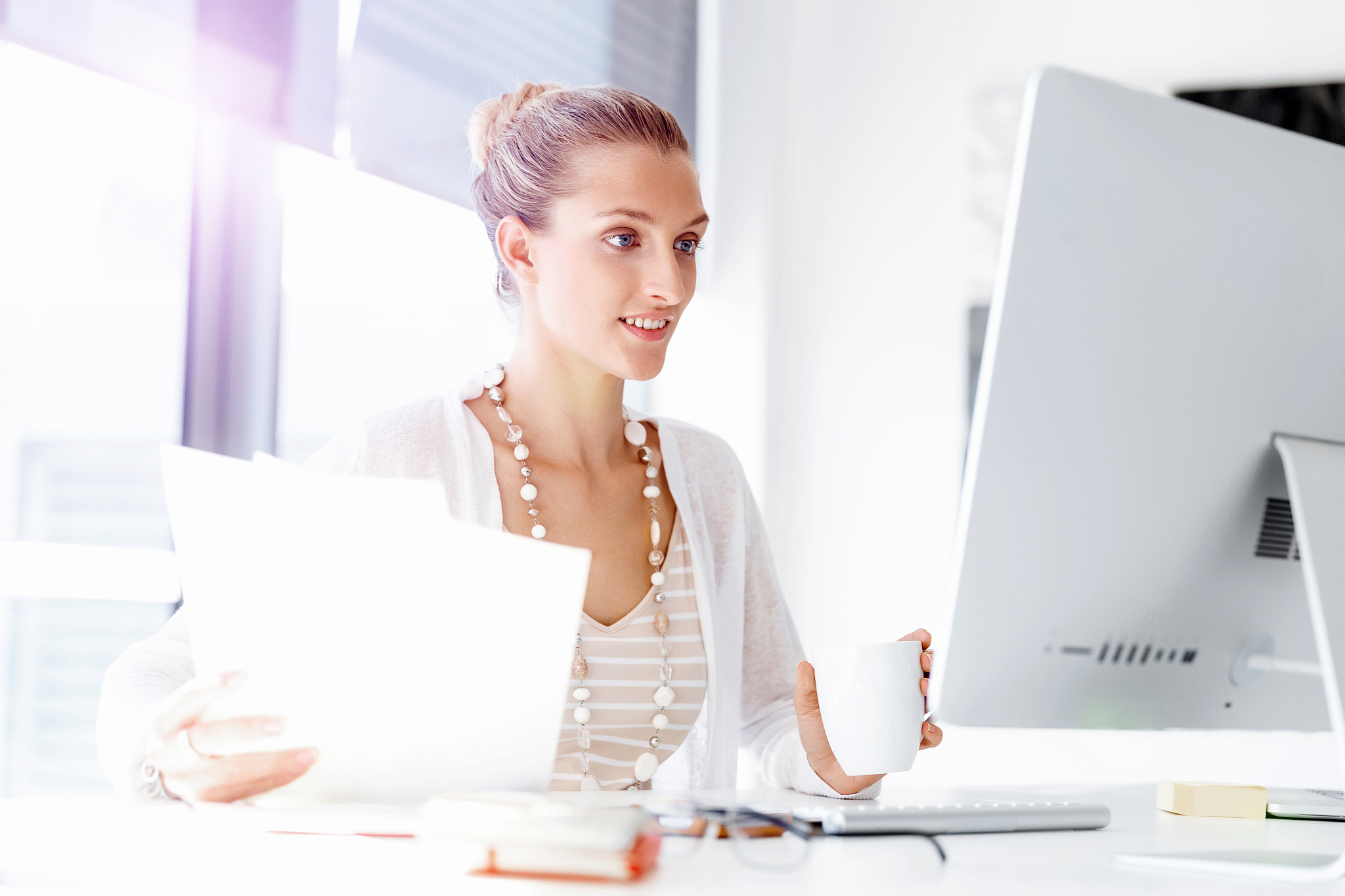 attractive office worker sitting at desk. attractive woman sitti