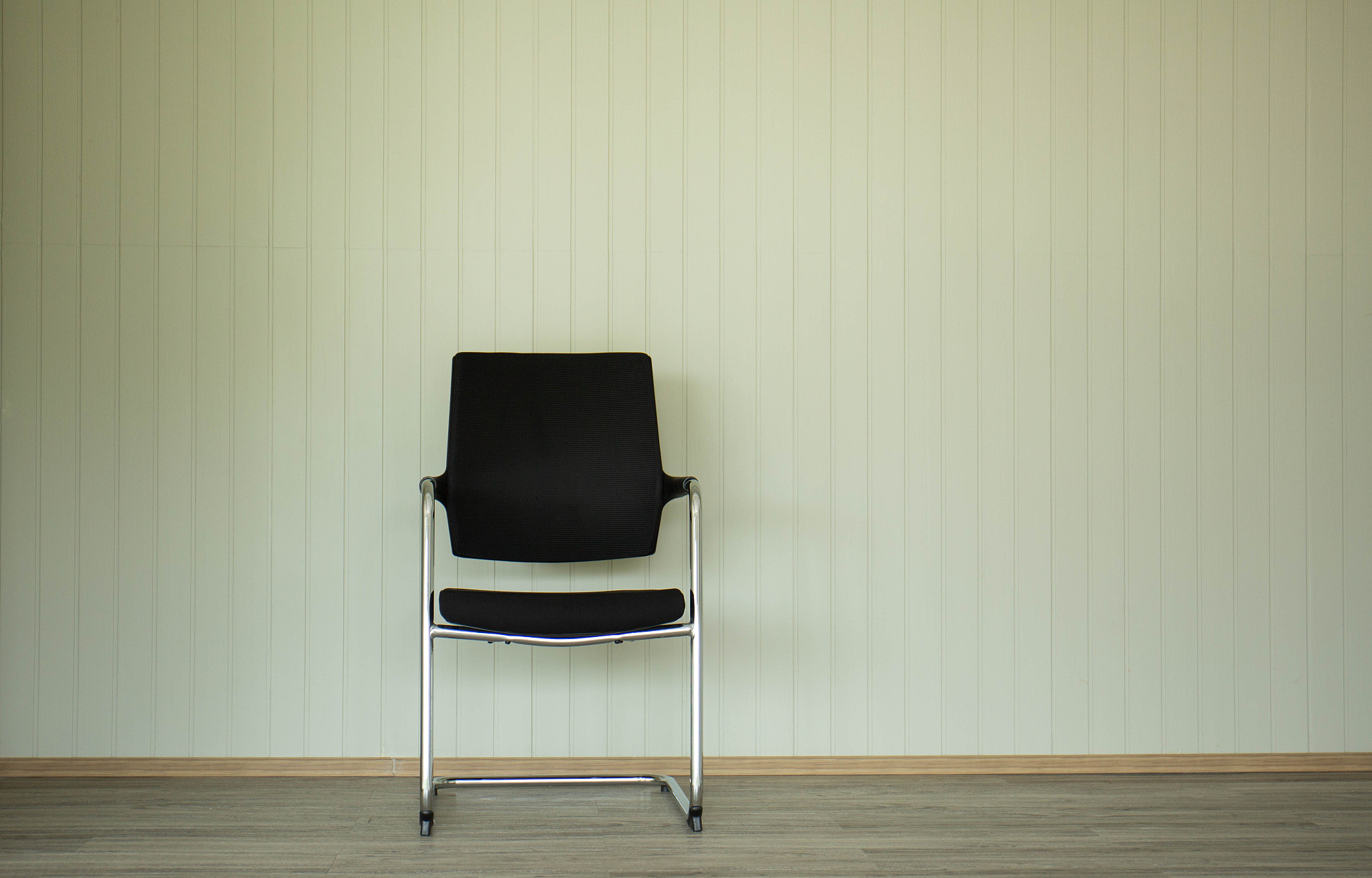 black chairs on the background are light-colored.