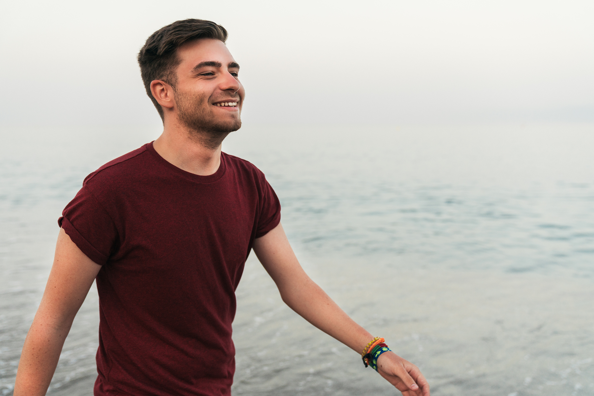 cheerful man walking along seaside