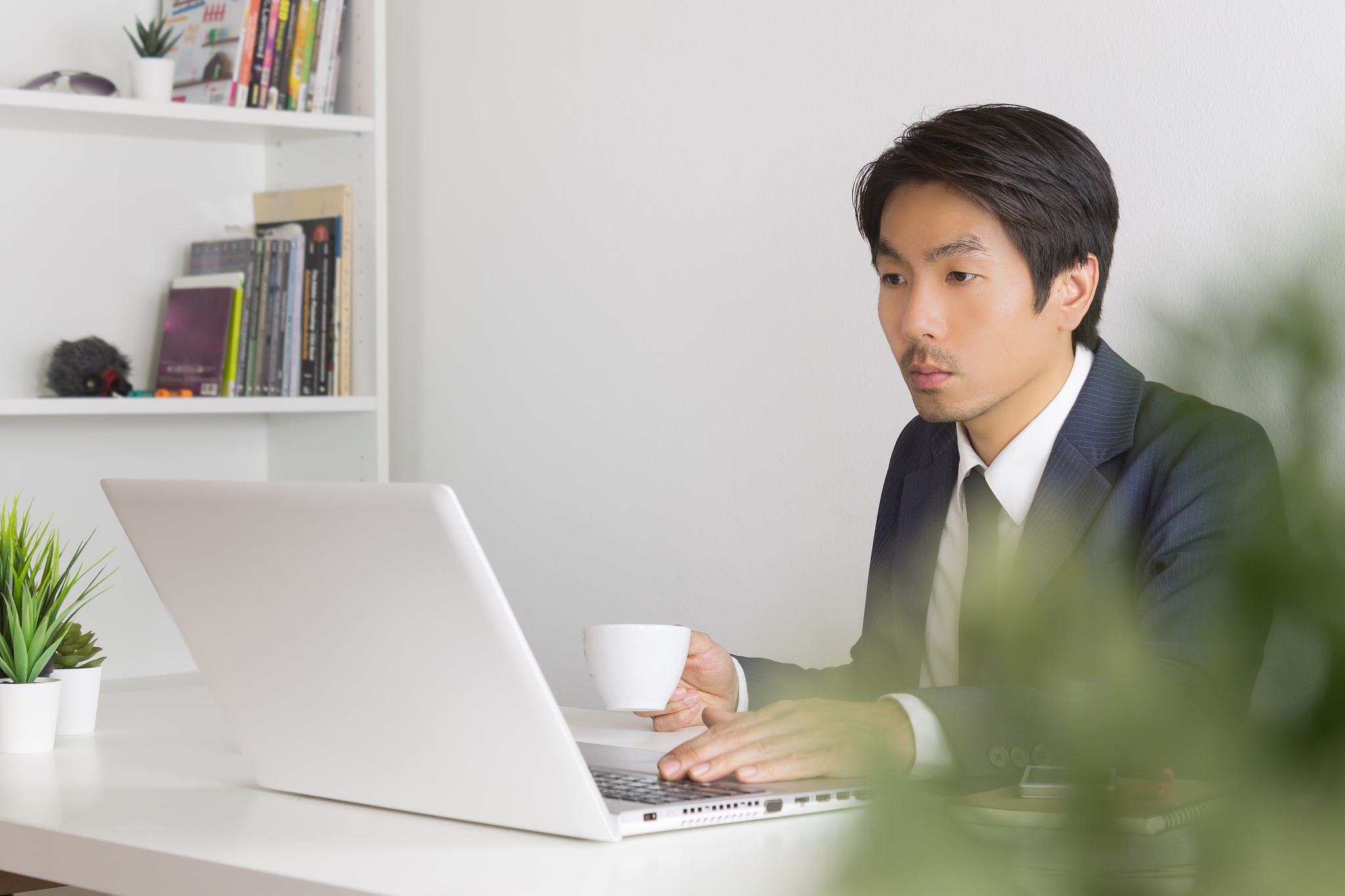 asian businessman with coffee cup in break time with tree foregr