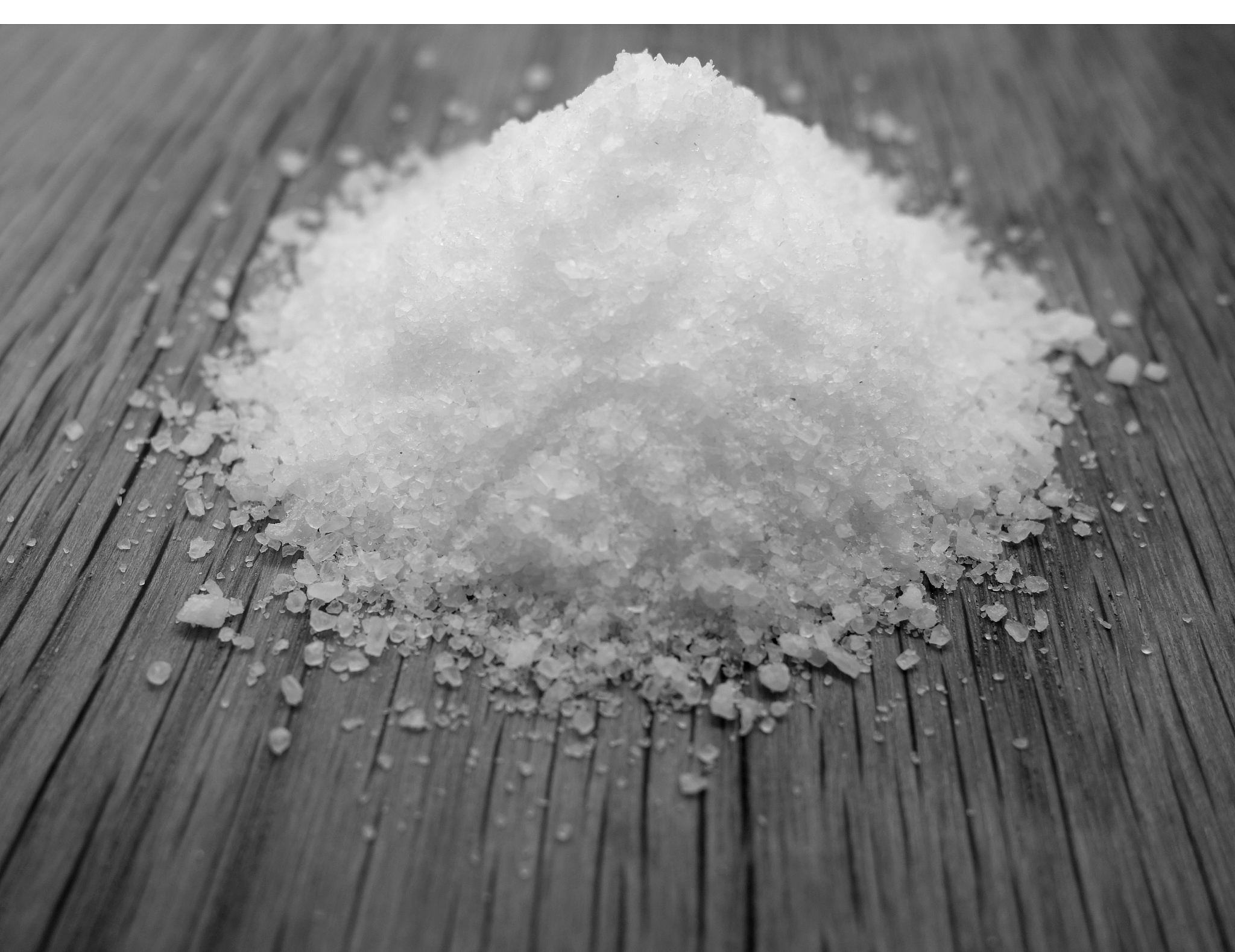 sea salt on wooden board in black and white.