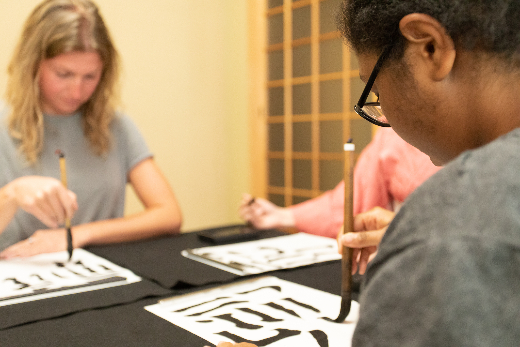 foreign people learning japanese calligraphy