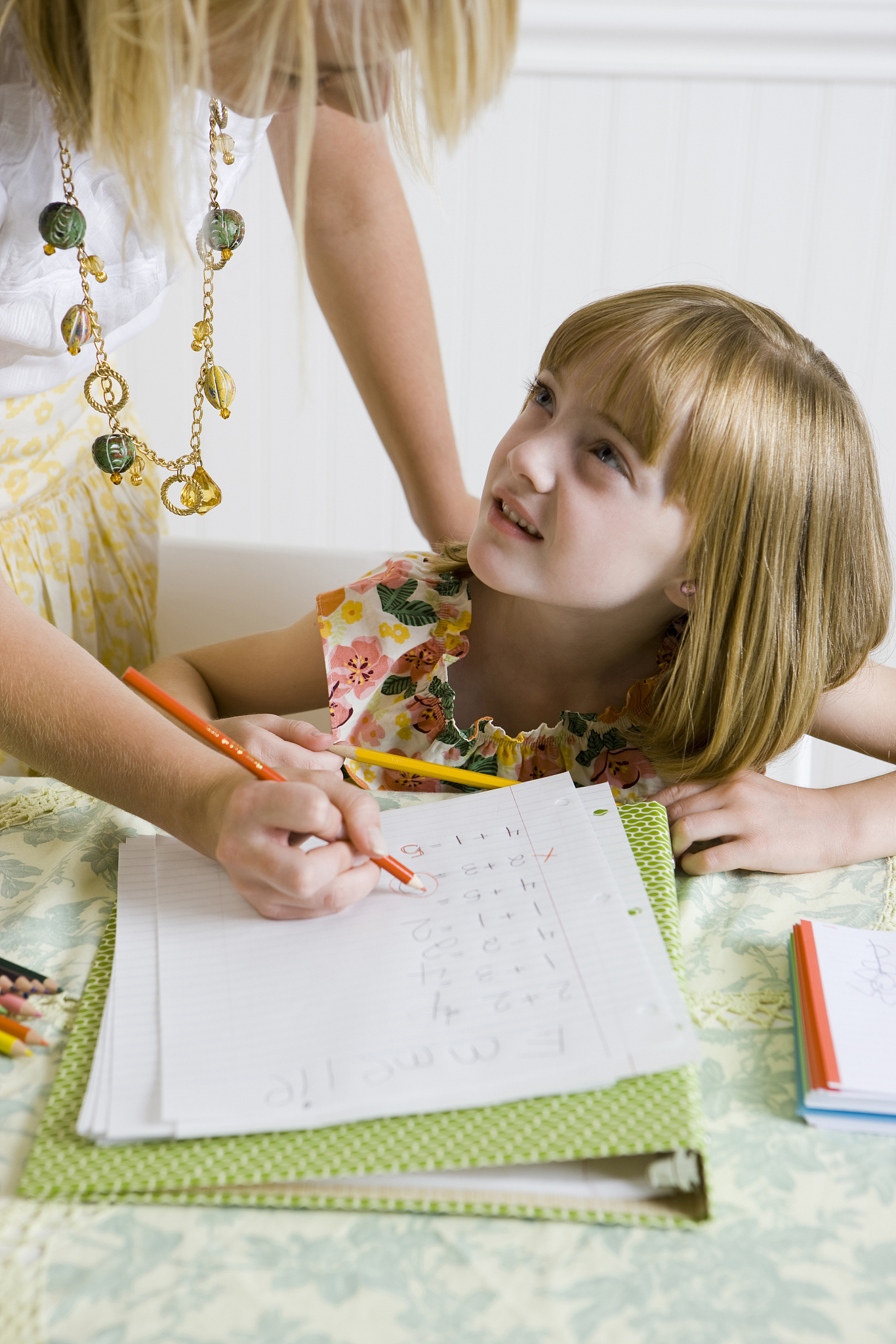 girl doing homework at the kitchen table