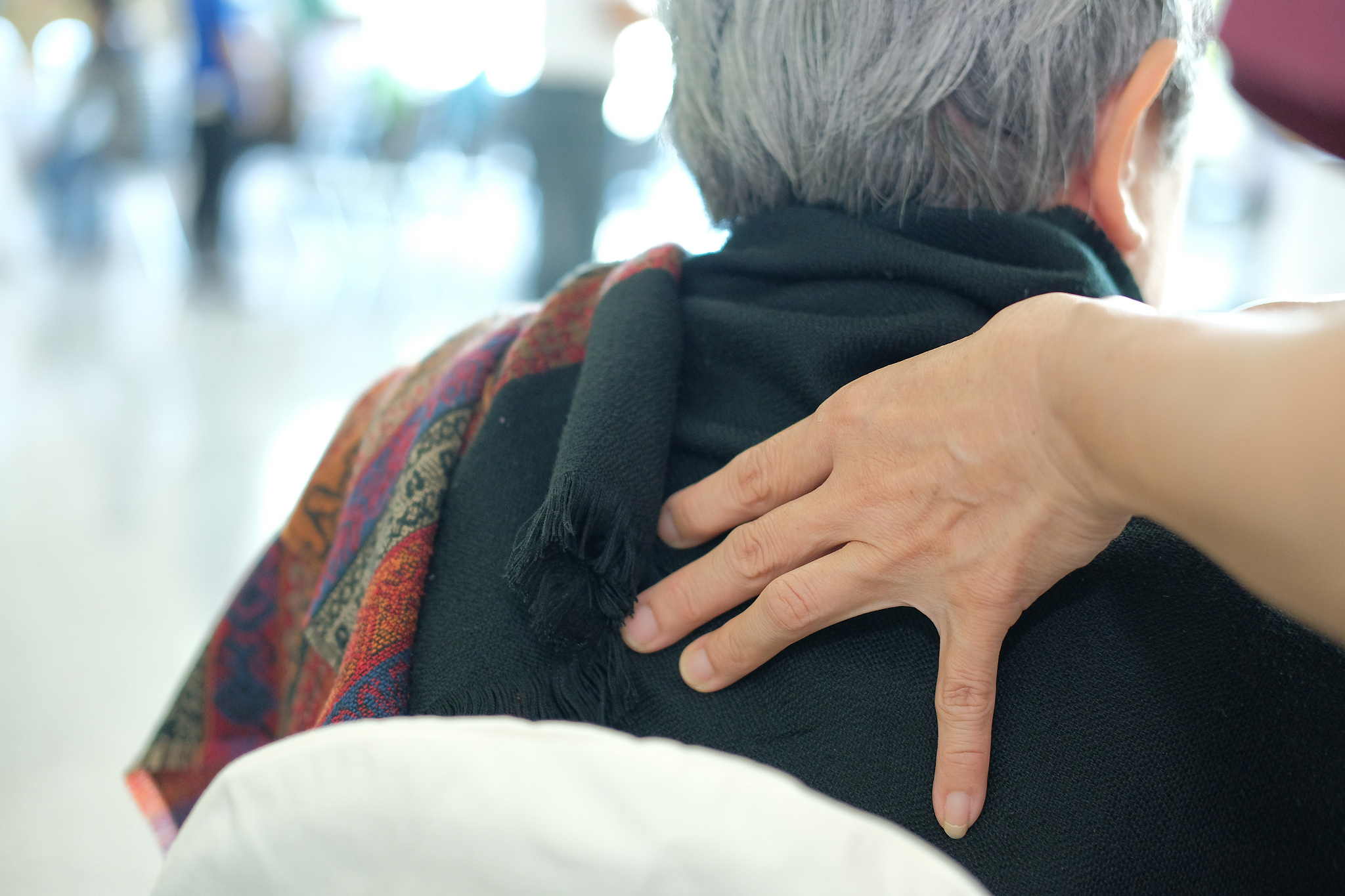 physiotherapist massage old woman shoulder