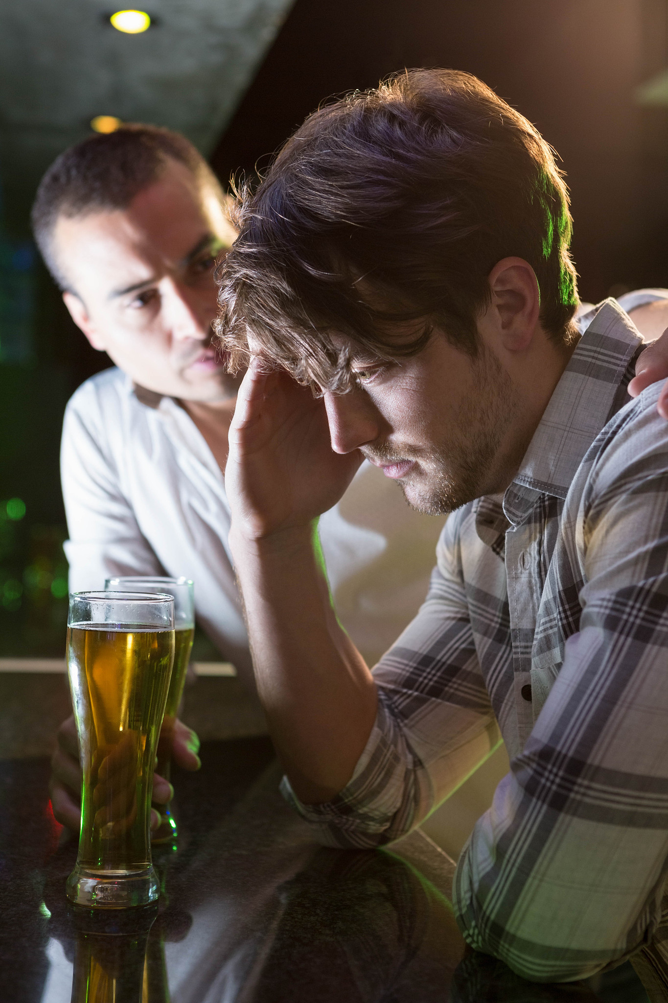 man comforting his depressed friend