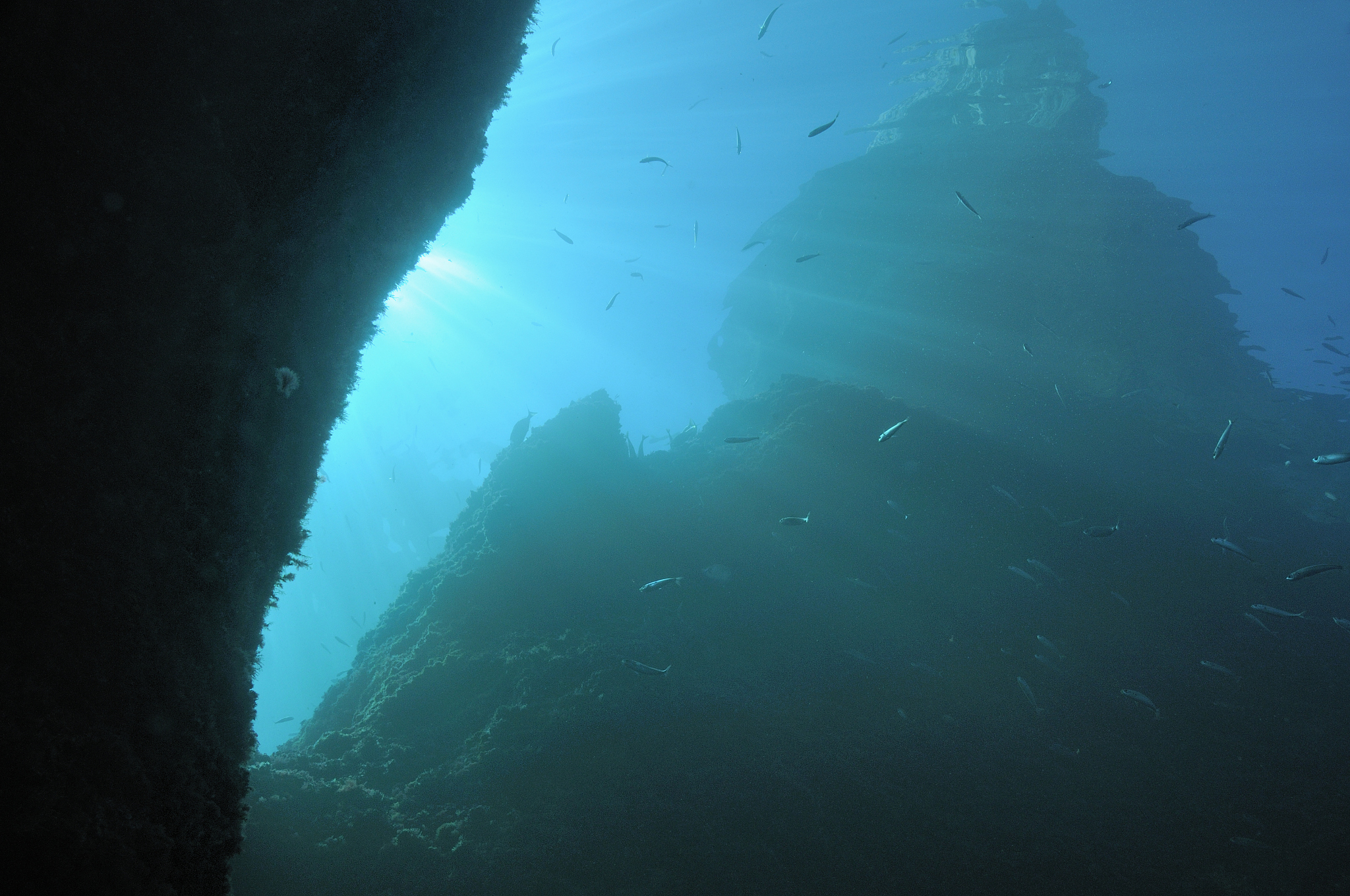 sunbeams and rock formation underwater