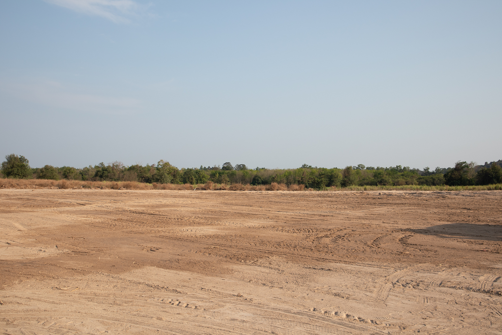 empty dirt field on sunny day at thailand