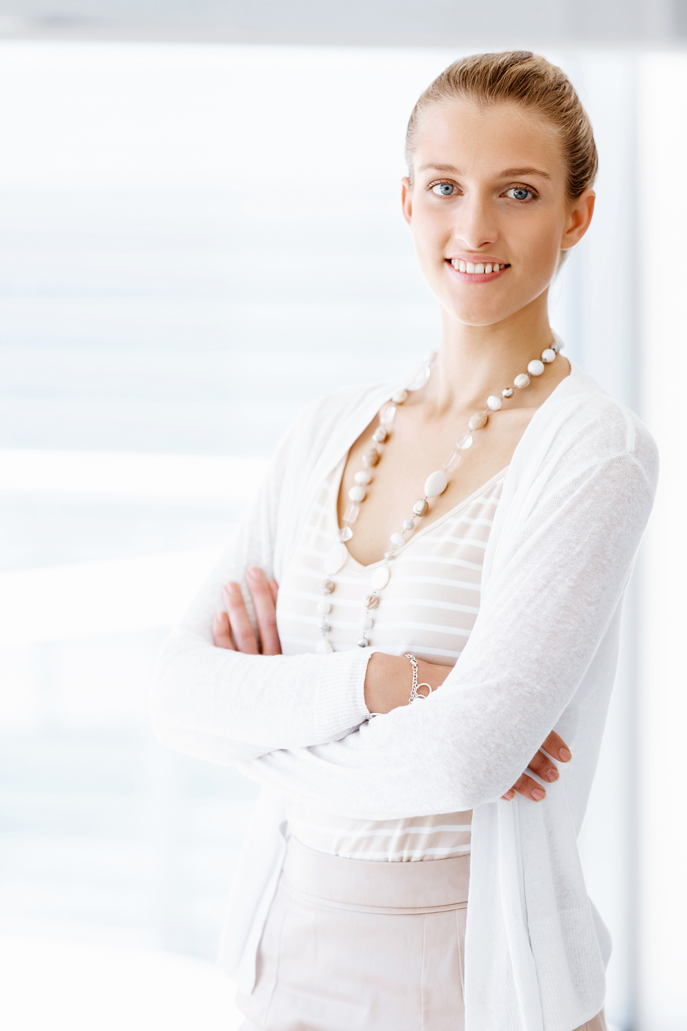 attractive office worker standing next to window. attractive wom