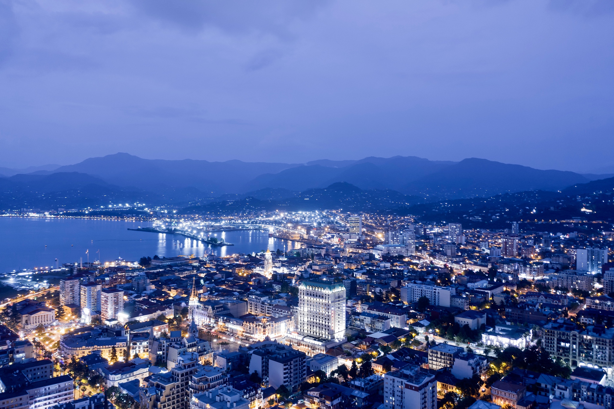 high angle view of illuminated city against sky at dusk