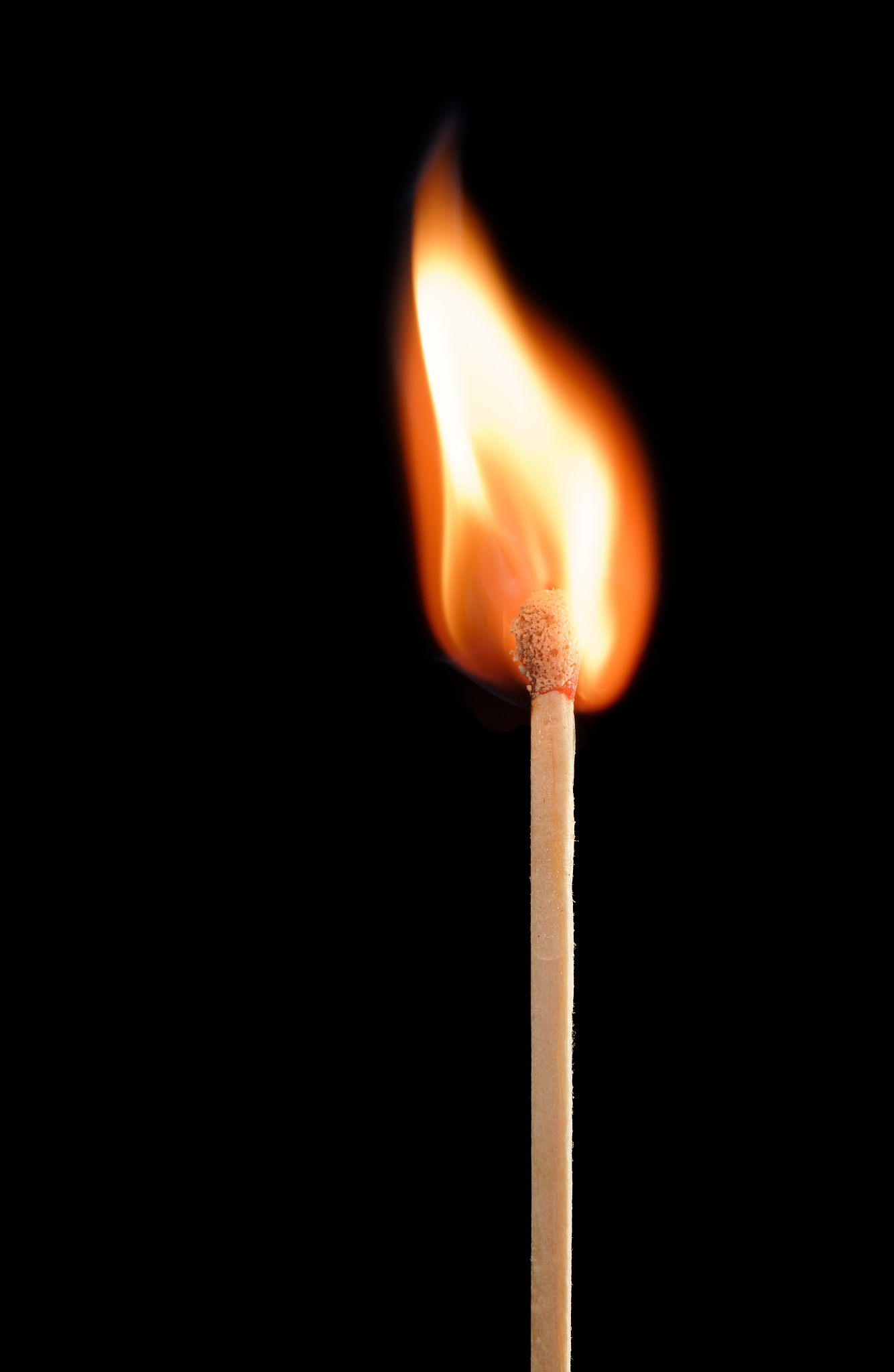 match ignited against black background