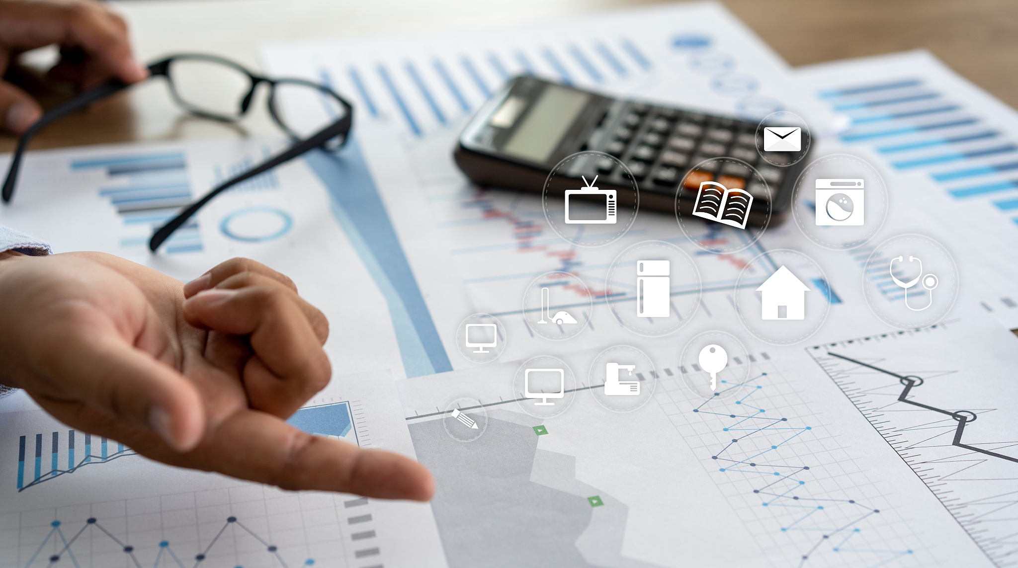 cropped hands of person pointing on graphs in office