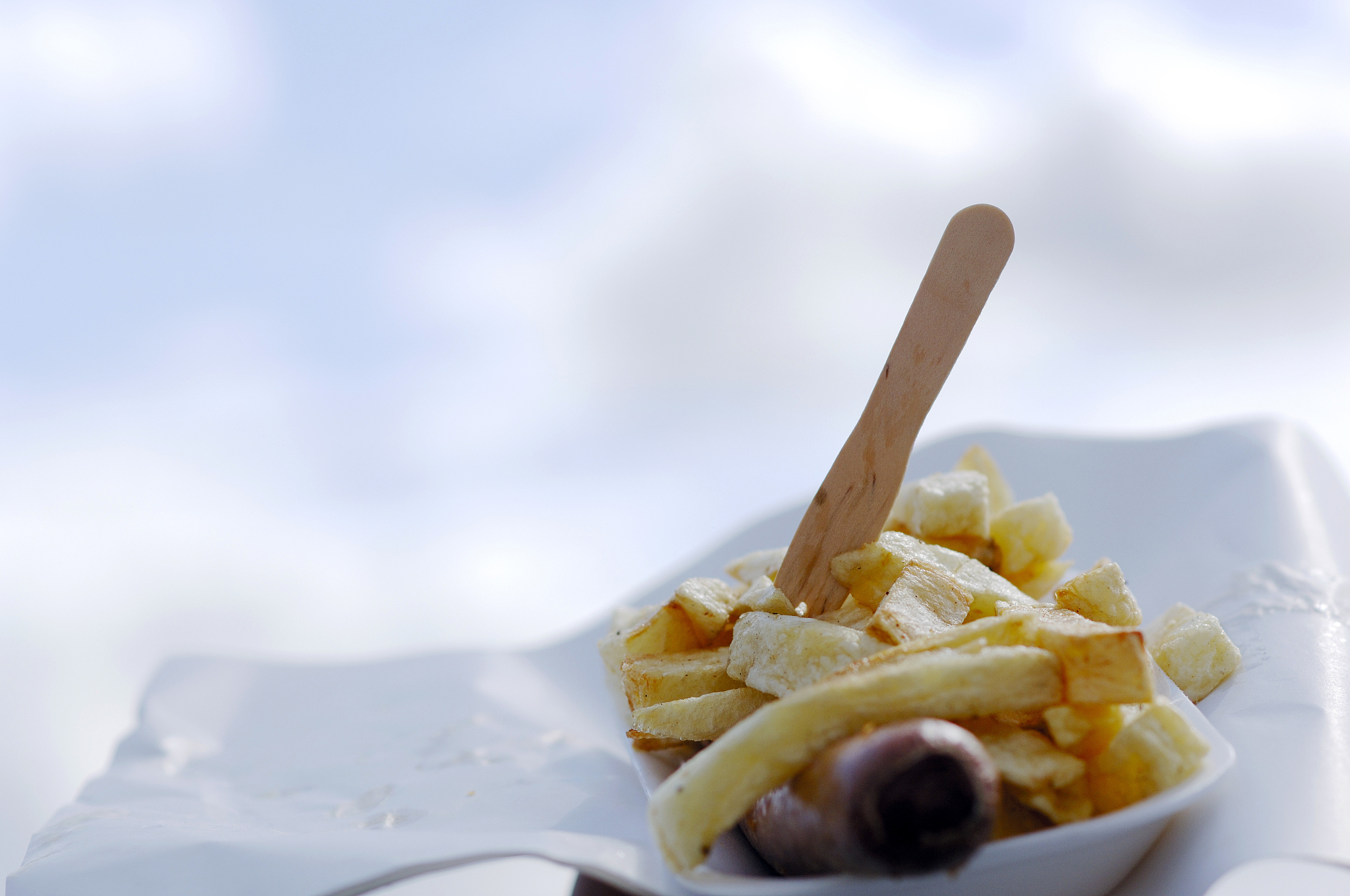 takeout jumbo sausage &amp; chips, wrapper against cloudy sky