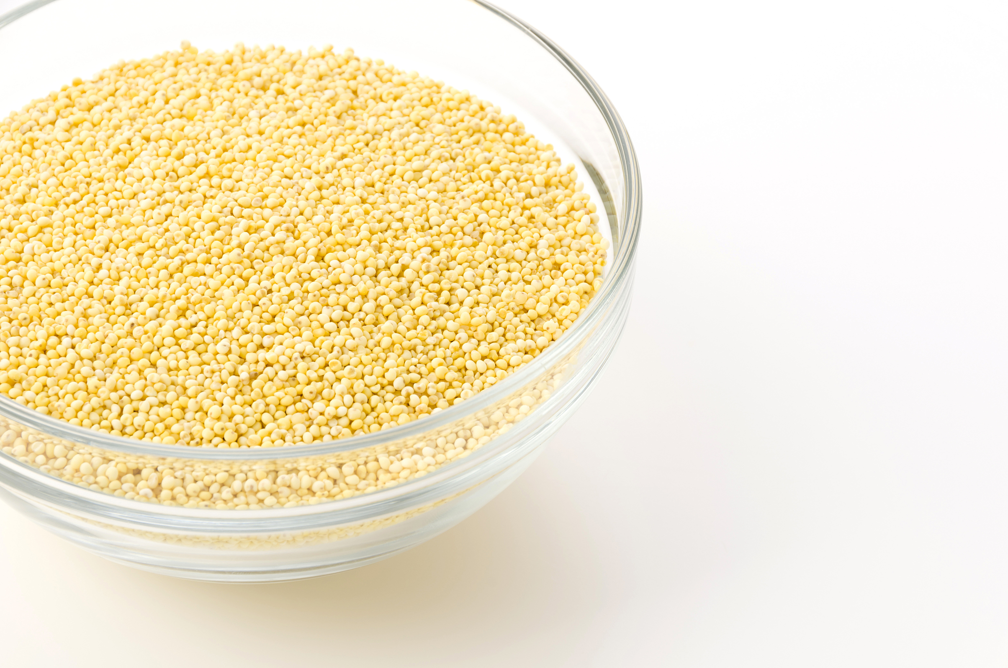 glutinous millet in glass bowl on white background