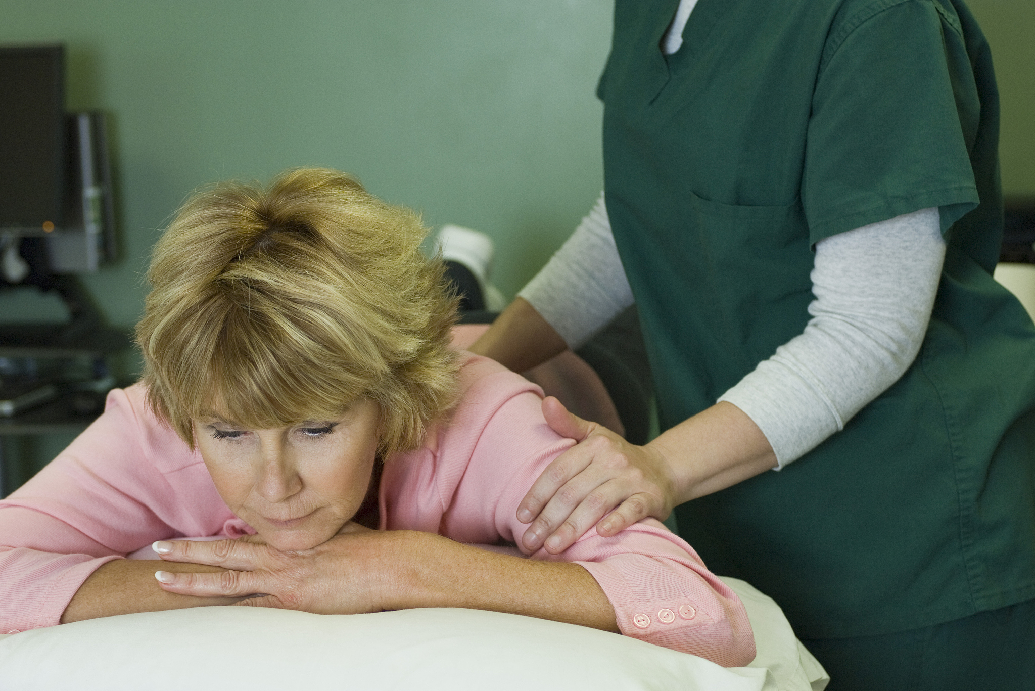 woman enjoying massage by physical therapist