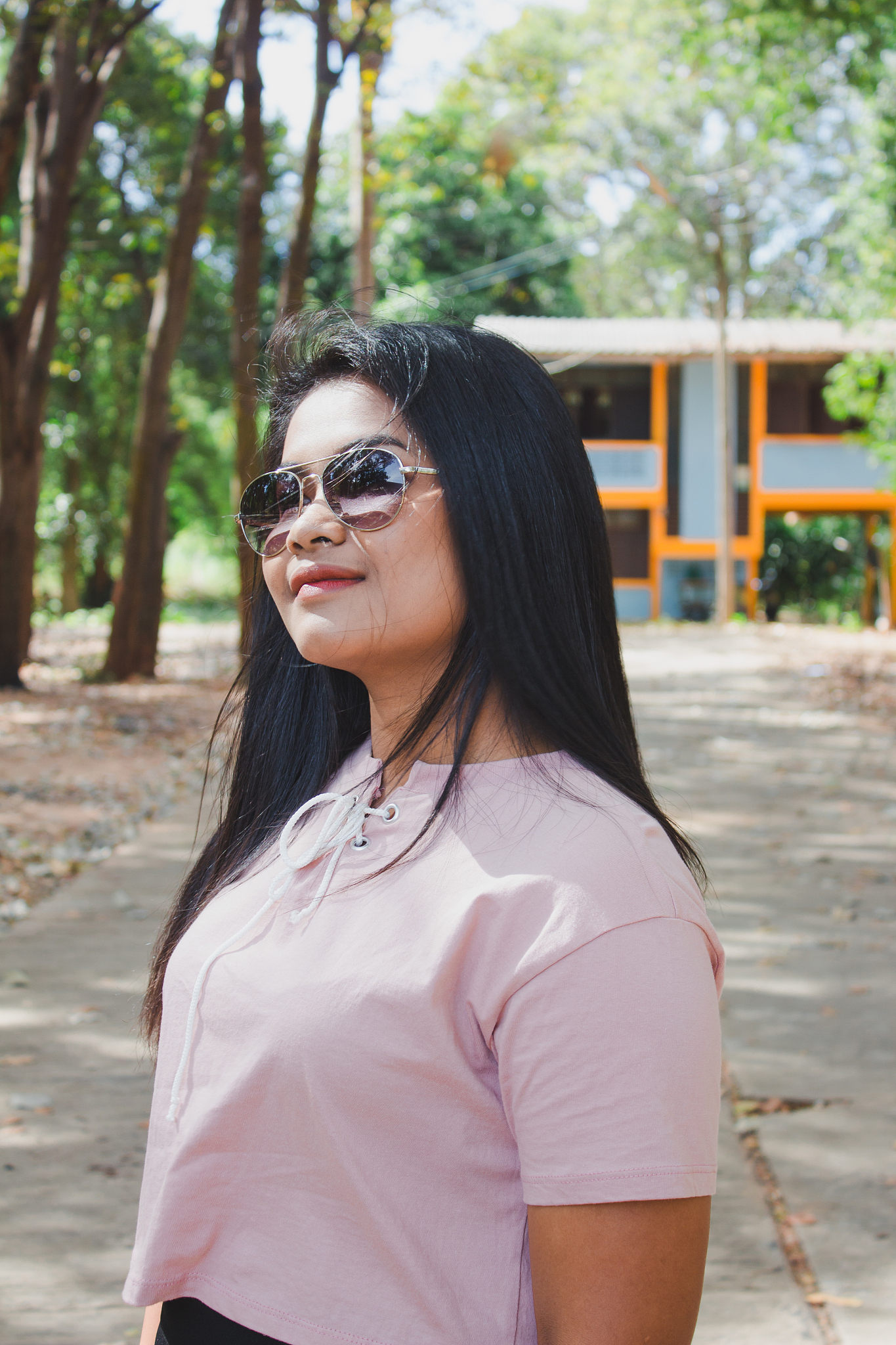 woman wearing sunglasses standing on road