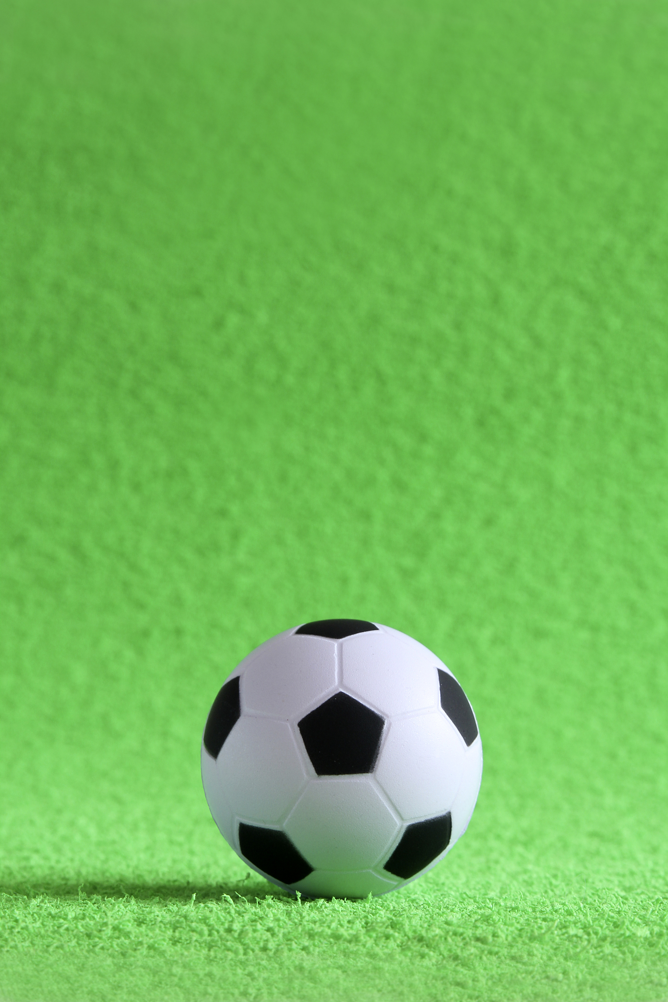 small soccer ball on a green artificial football field. football