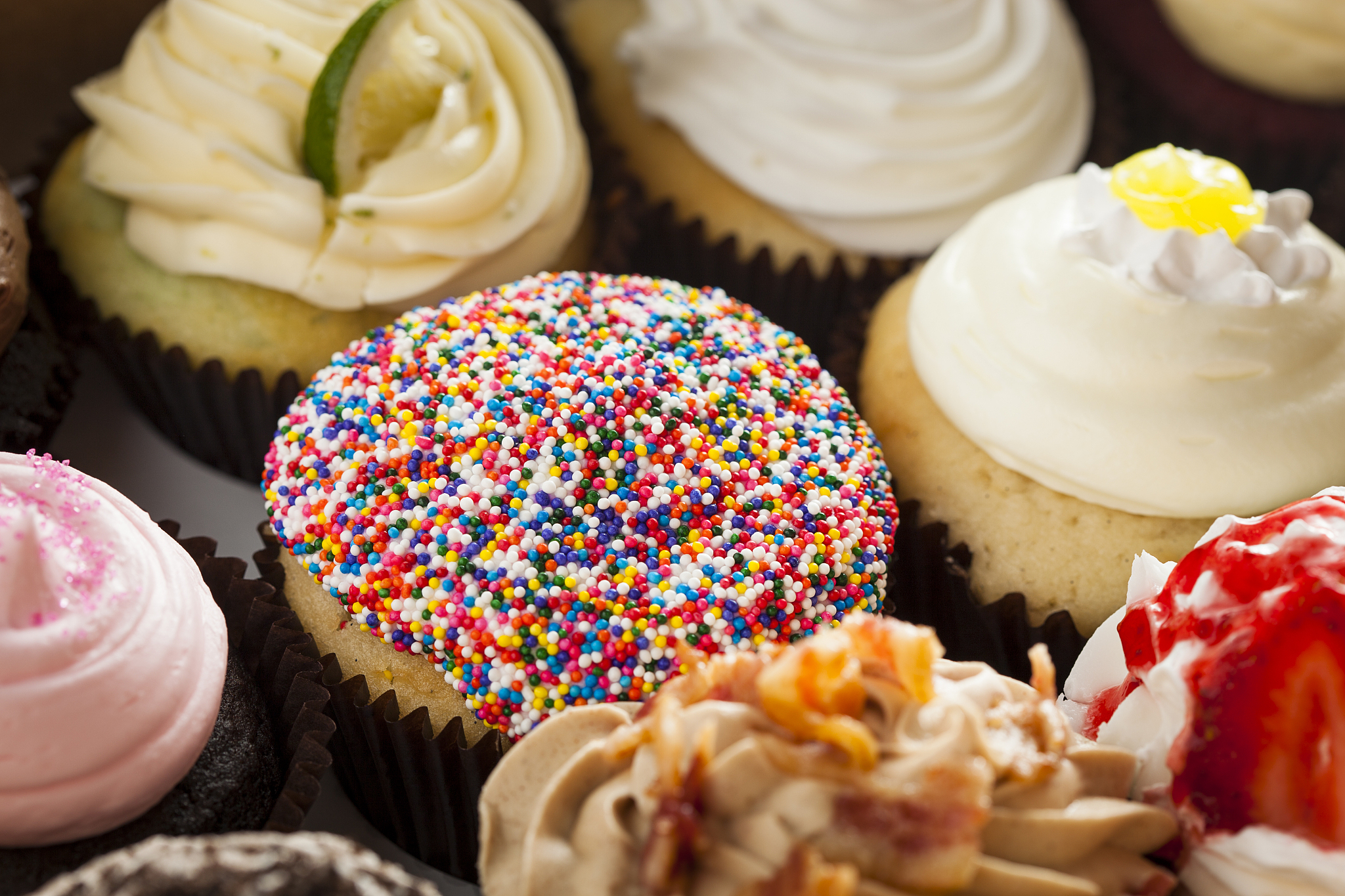 assorted fancy gourmet cupcakes with frosting