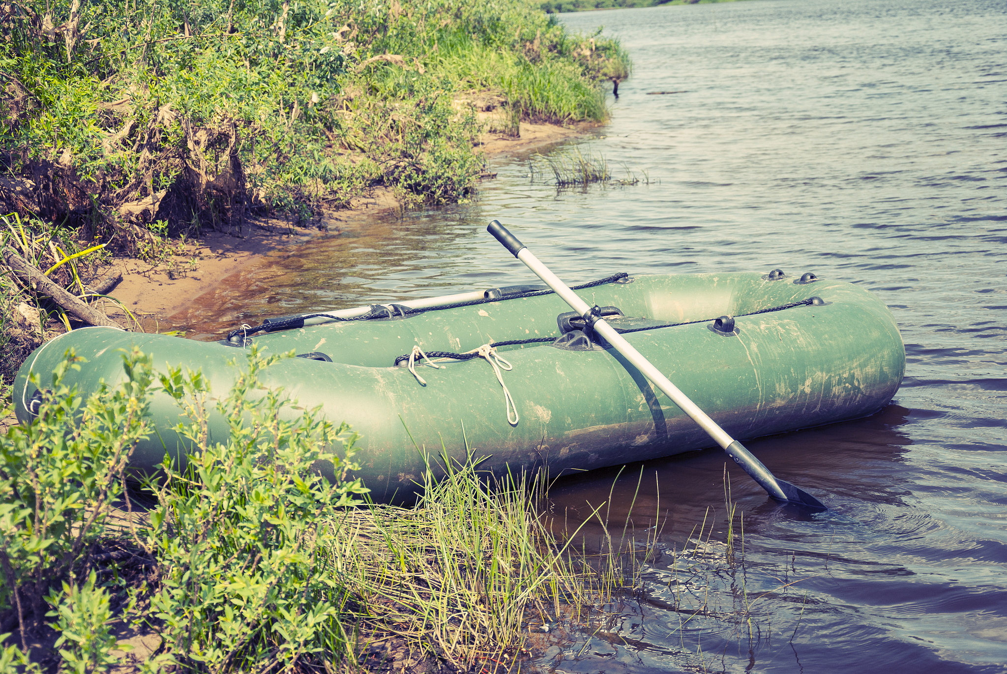 inflatable boat on the a river near shore