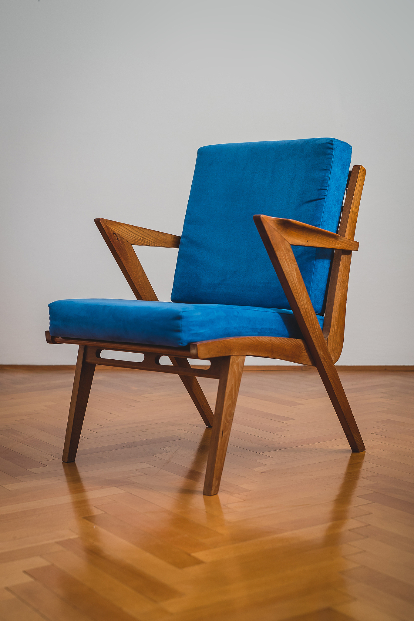 a wooden chair with blue padding.