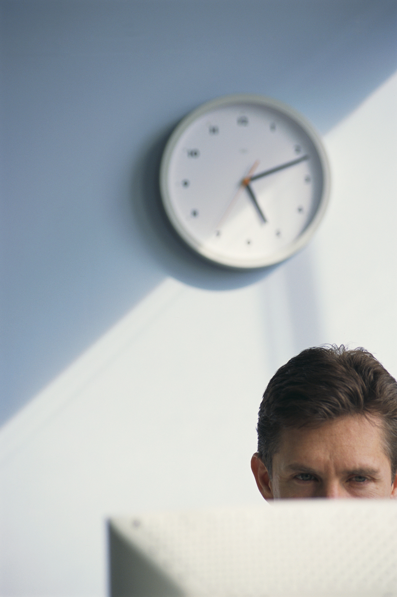 computer user and wall clock