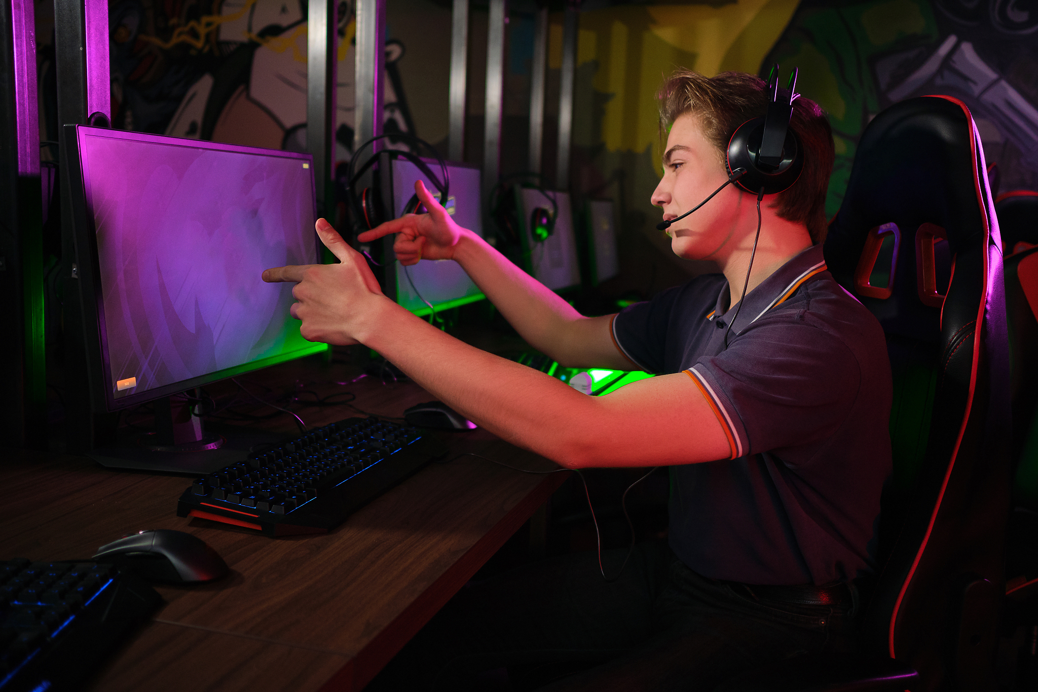 professional young caucasian gamer playing online on his pc. he 