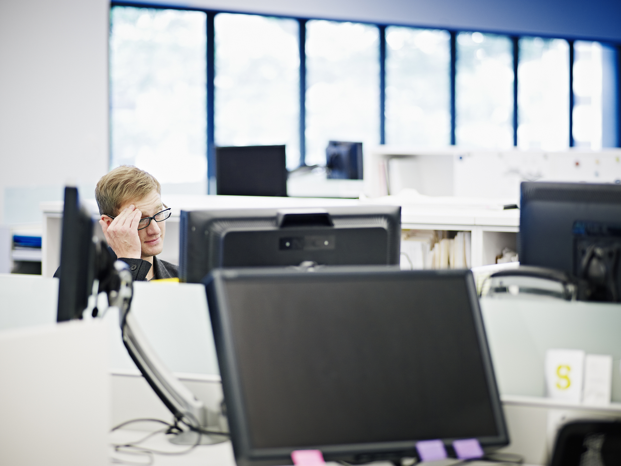 businessman in office looking at computer monitor