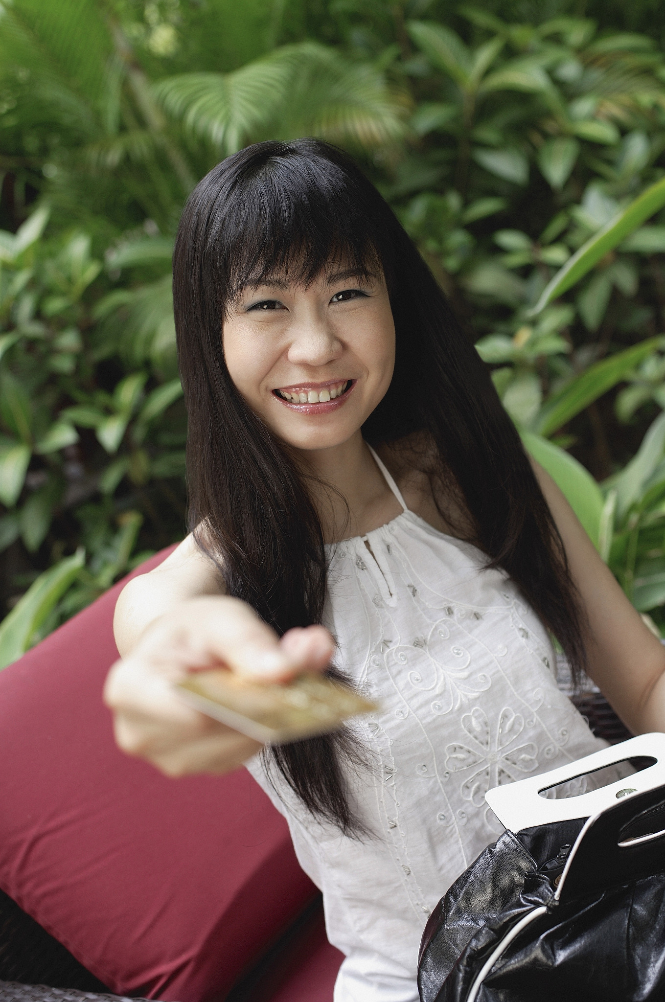 woman holding out credit card