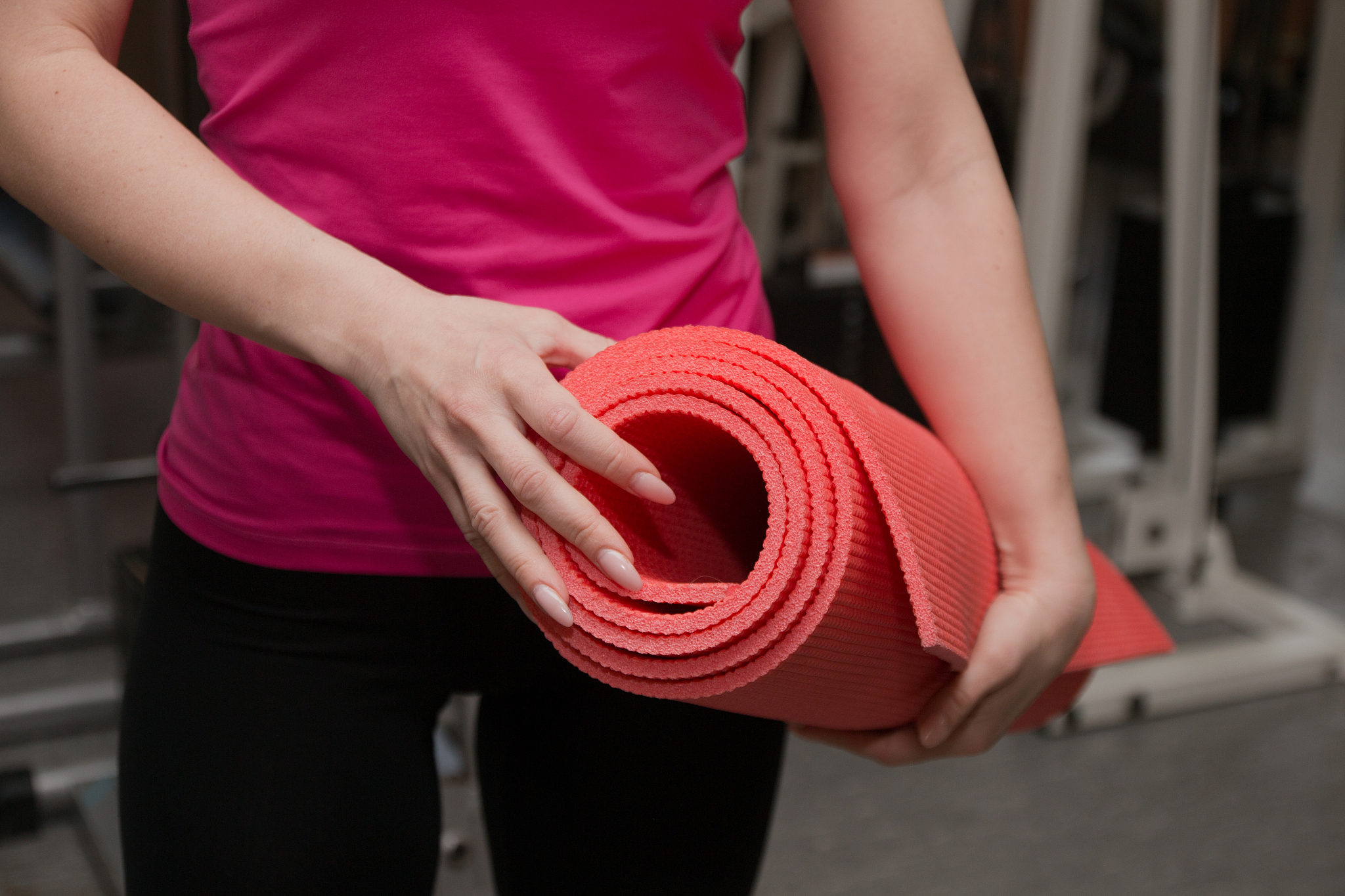 beautiful girl exercising in a fitness club on the rug
