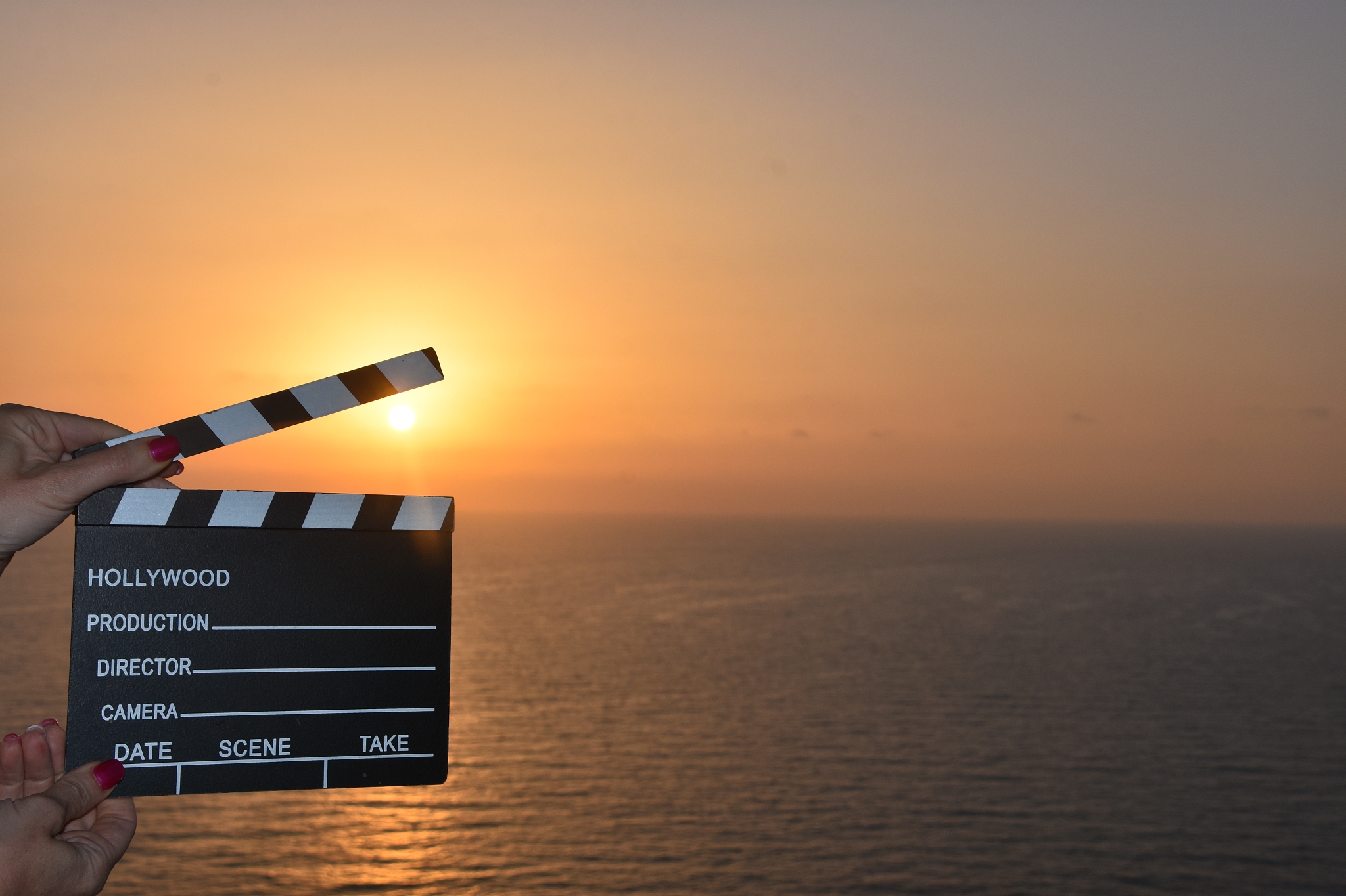 concept - movie clapper at sunset