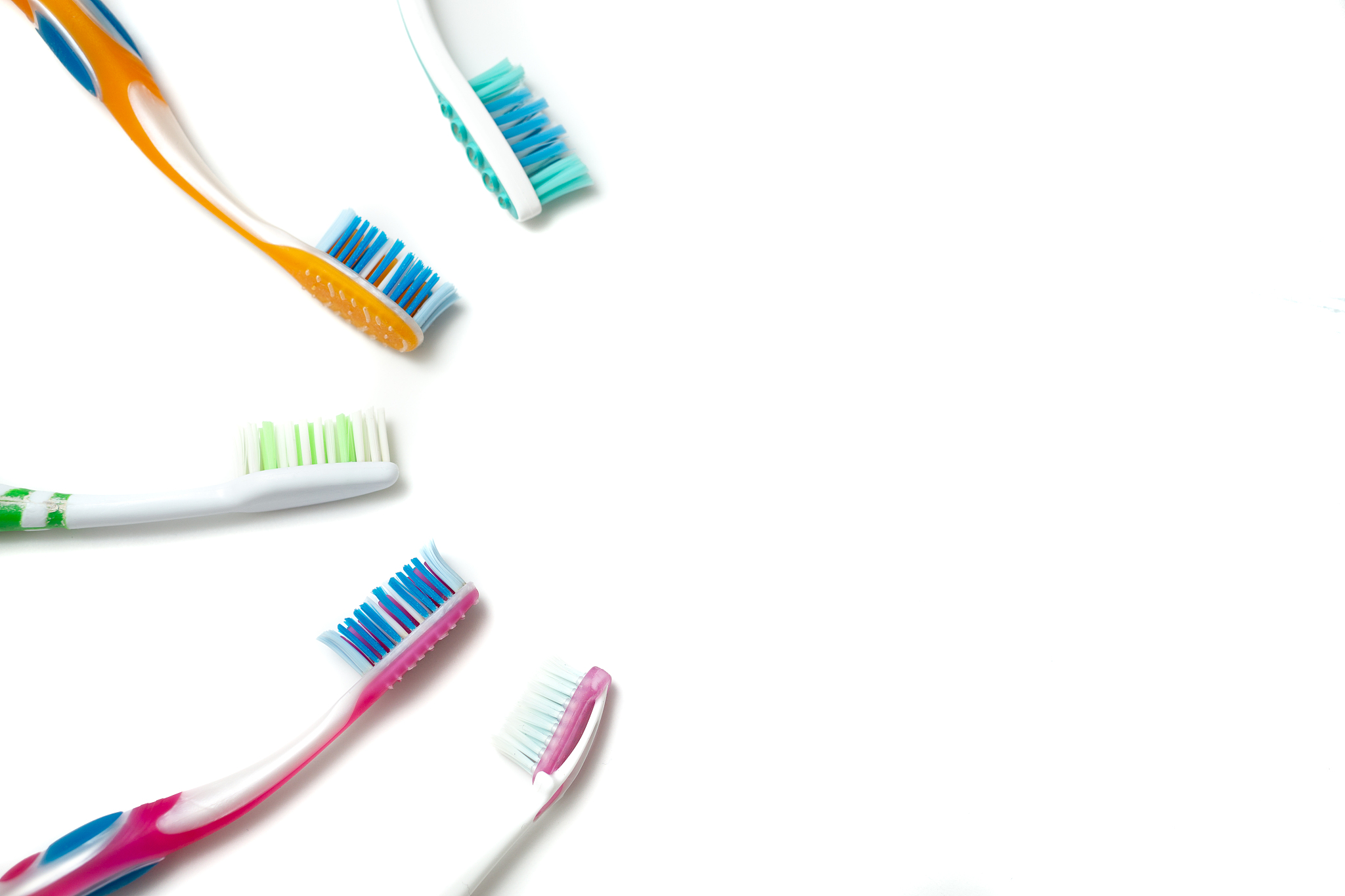 used toothbrushes on a white background
