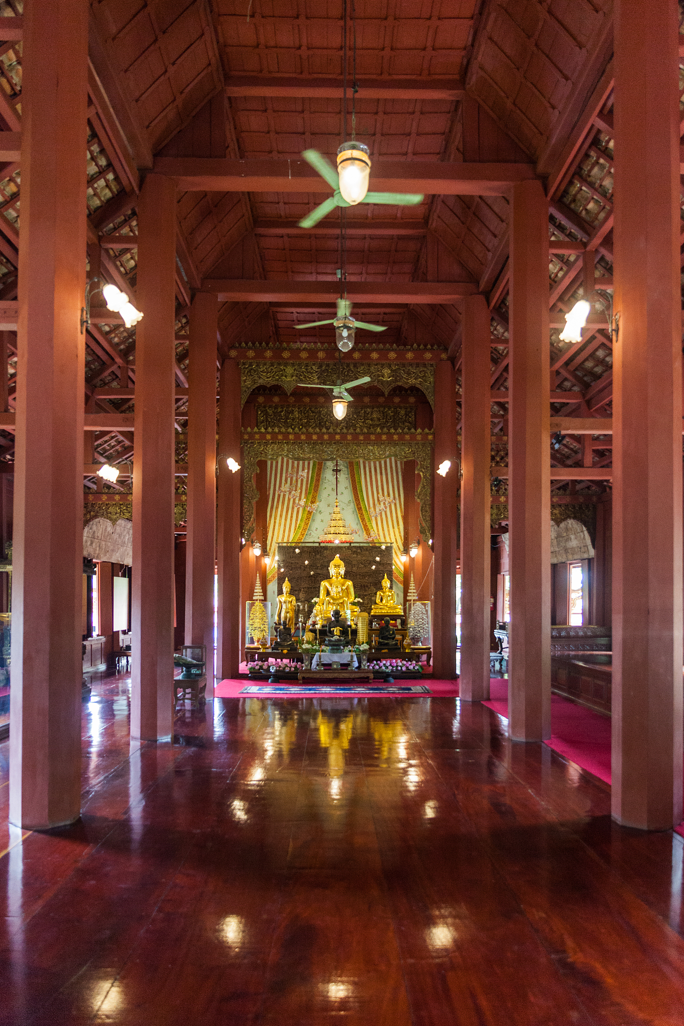 golden buddha statue in wooden temple