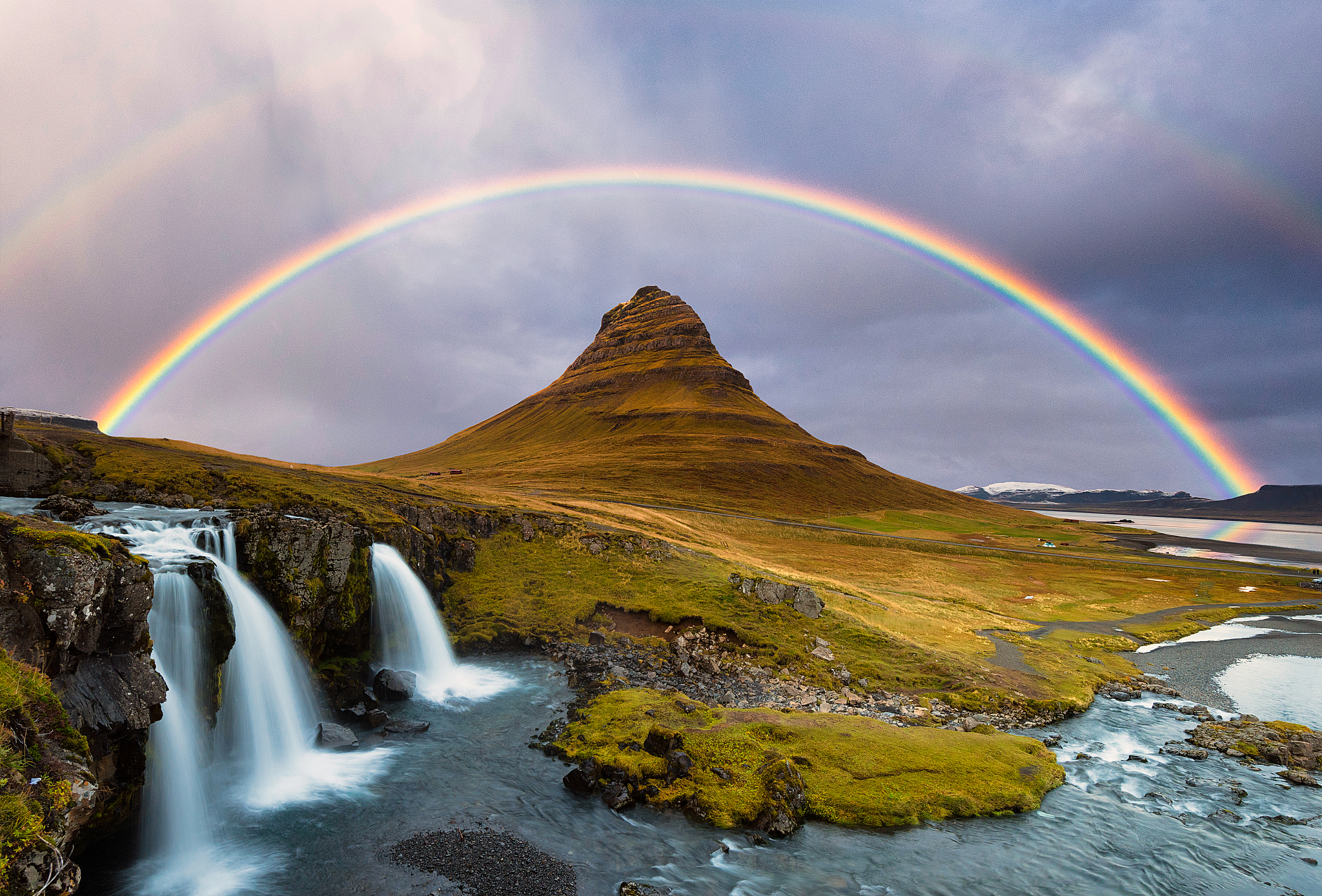 kirkjufell mountain and kirkjufellsfoss waterfalls against the r