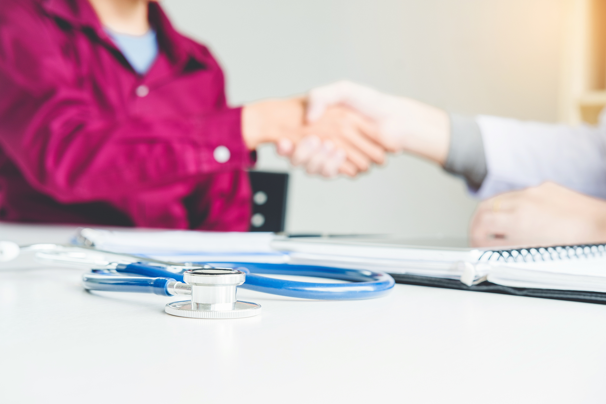 confident doctor shaking hands with patients talk in the hospita