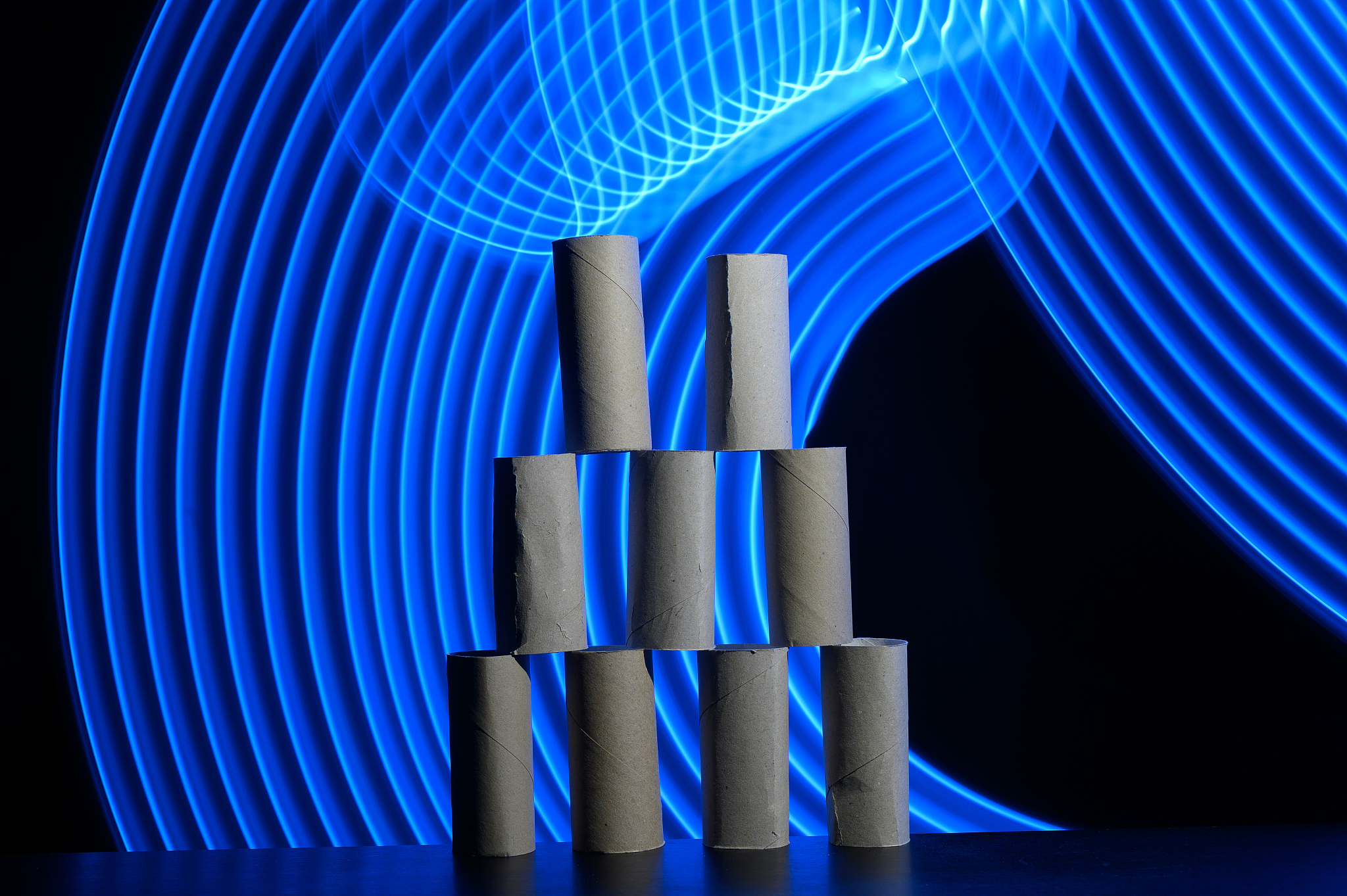 tower of empty paper rolls in a futuristic background with curve